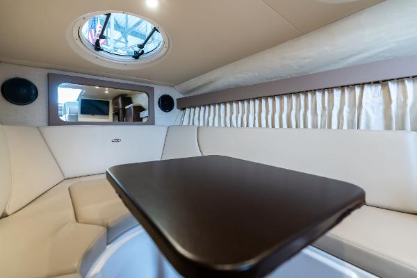 2016 Regal 28 Express cabin interior with seating, table, and porthole.