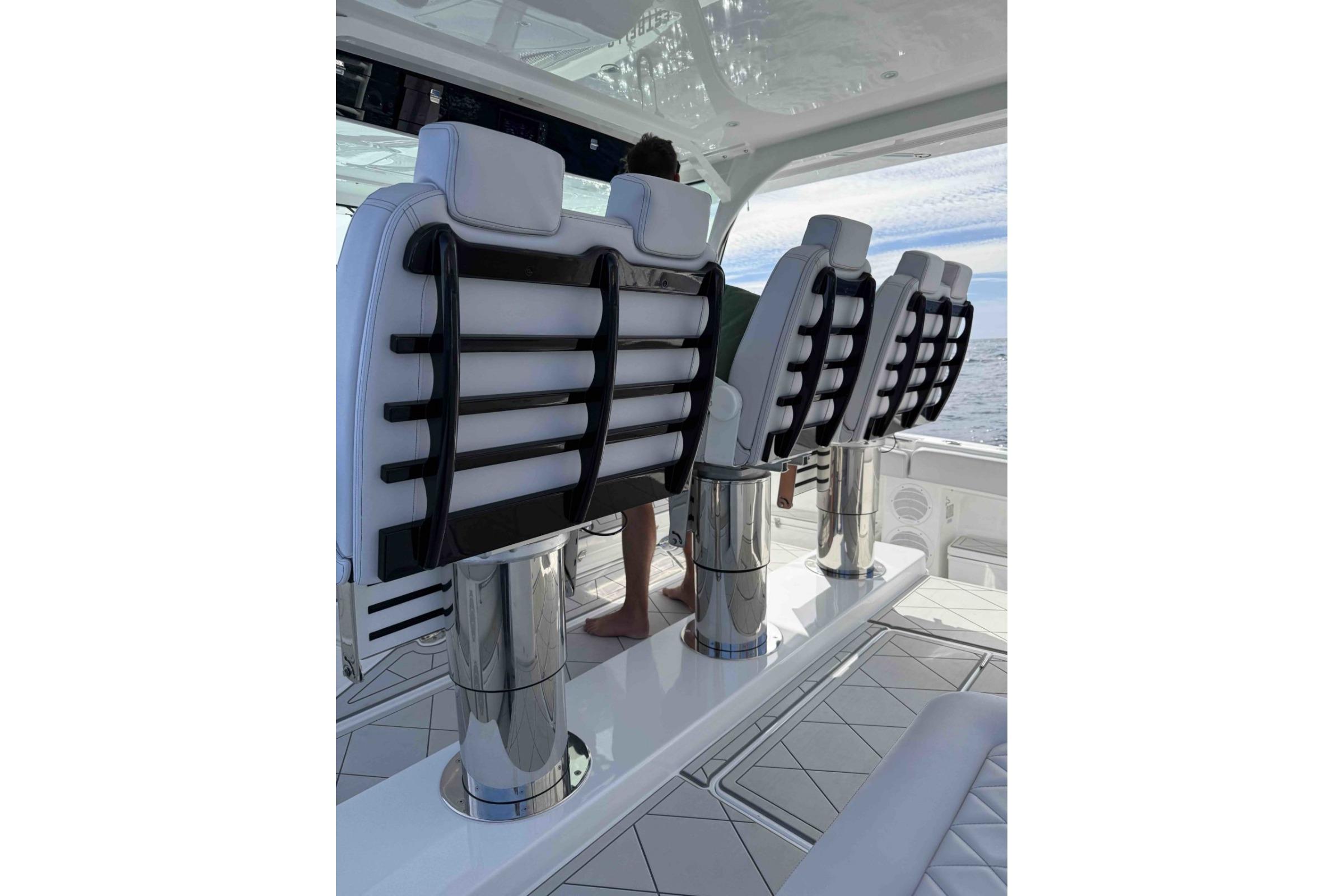 Luxury seating on 2022 HCB 65 Estrella yacht, featuring sleek design and ocean view.
