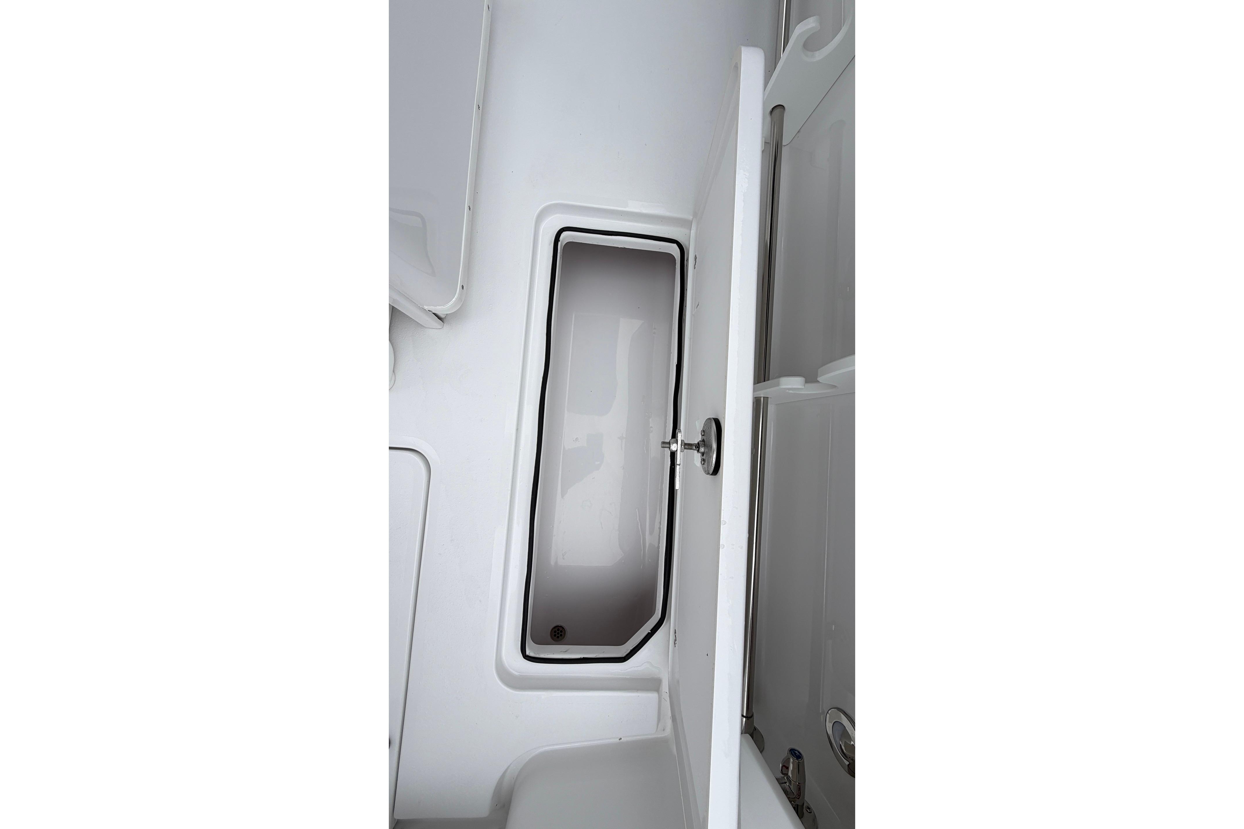 2026 Stingray 253 CC boat storage compartment with open hatch.