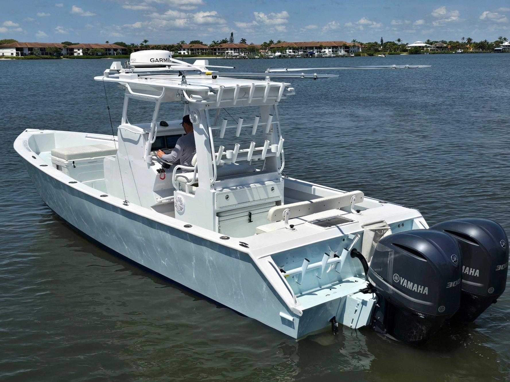 2012 Contender Custom 33 Center Console boat with dual Yamaha engines on a calm lake.