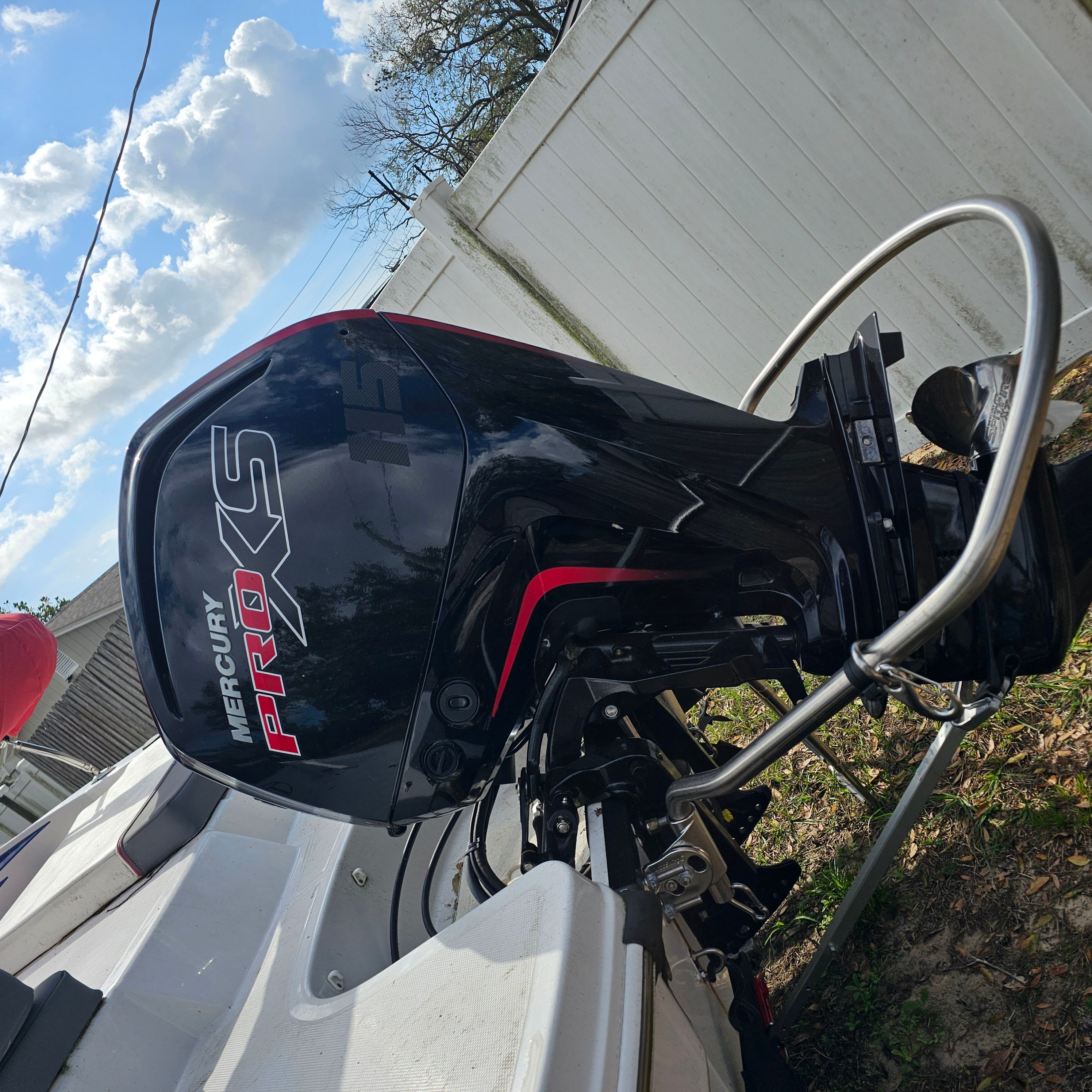 2024 Tahoe T18 boat with Mercury Pro XS outboard motor, parked outdoors.