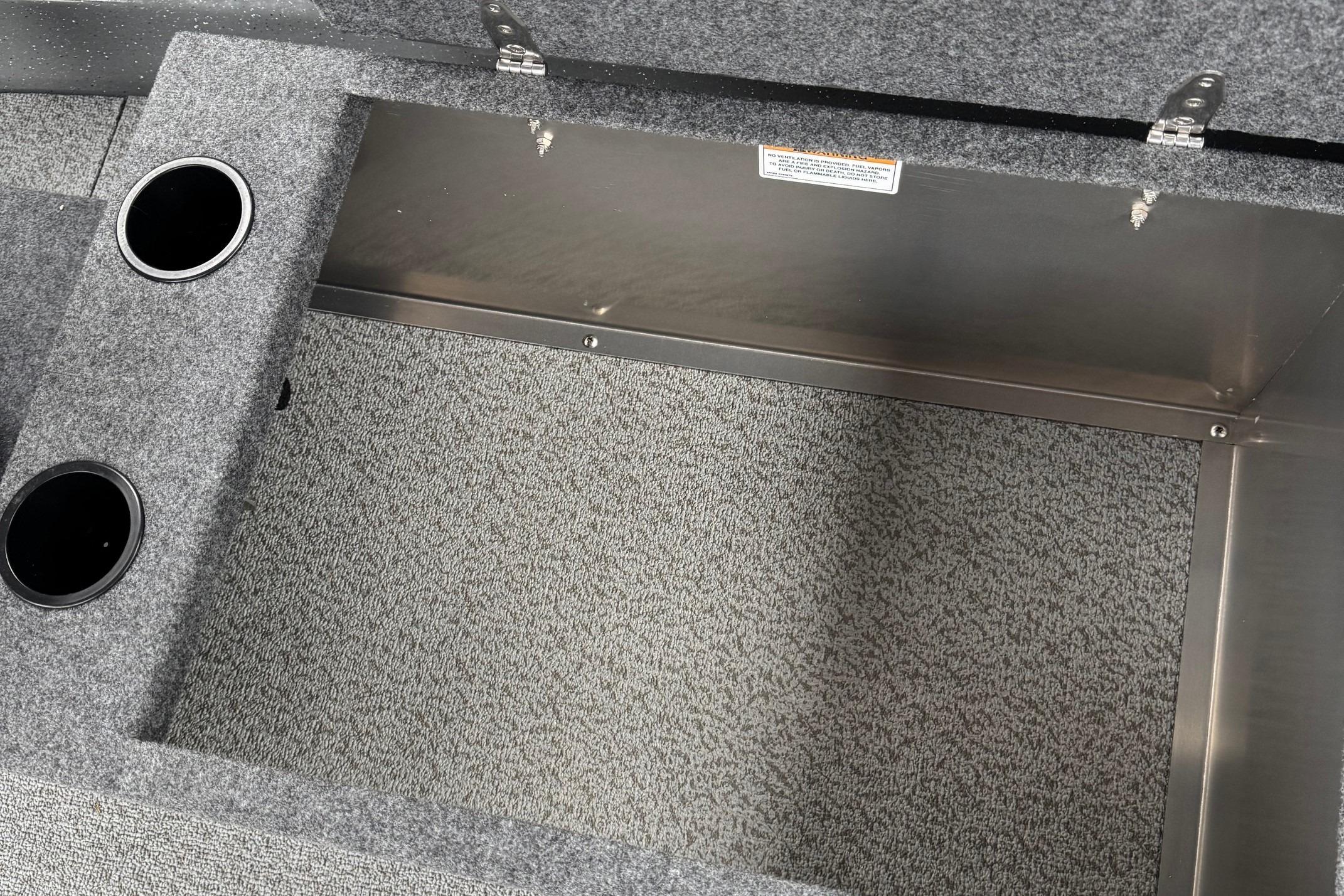 2024 Spartan 26 Maximus Pro XL storage compartment with carpeted interior and cup holders.