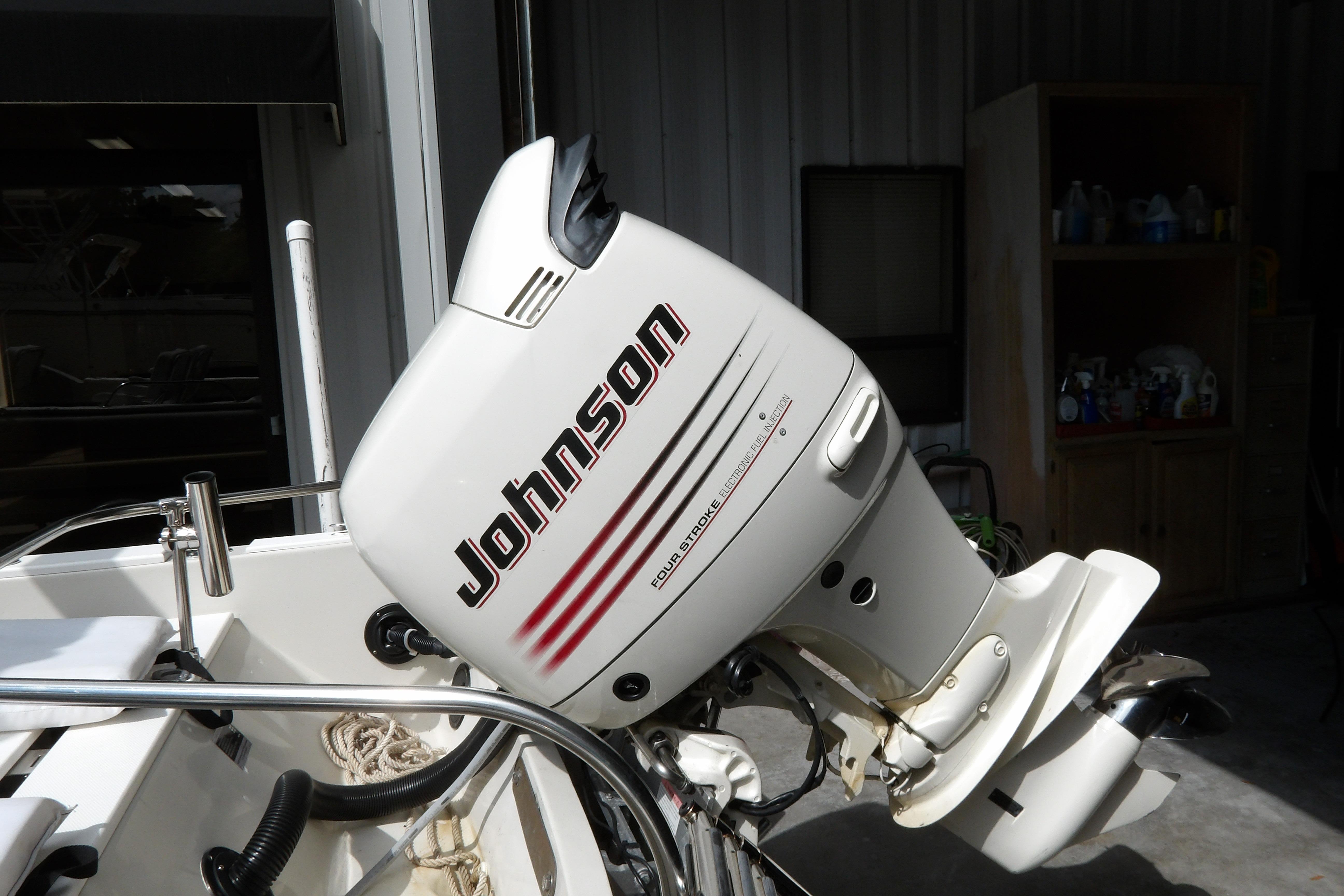 1978 Boston Whaler 21 Revenge with Johnson outboard motor in a garage setting.