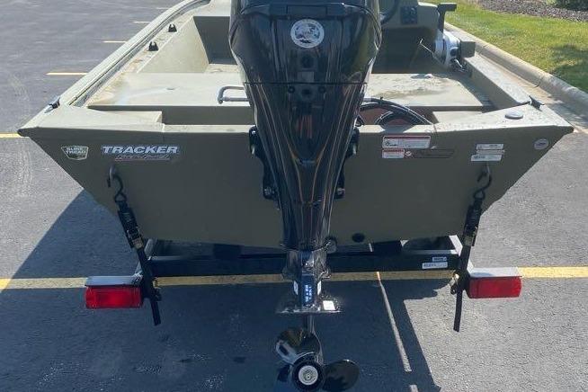 2026 Tracker Grizzly 1648 SC boat with outboard motor, parked on a trailer.