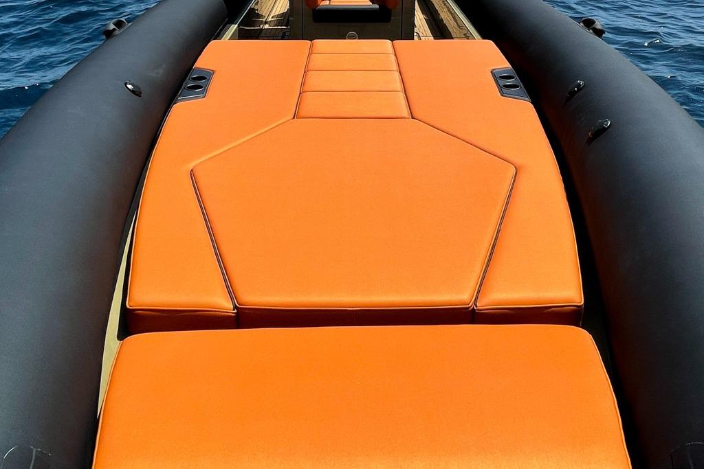 2026 Rock Marine RM 36 boat with vibrant orange seating on calm water.
