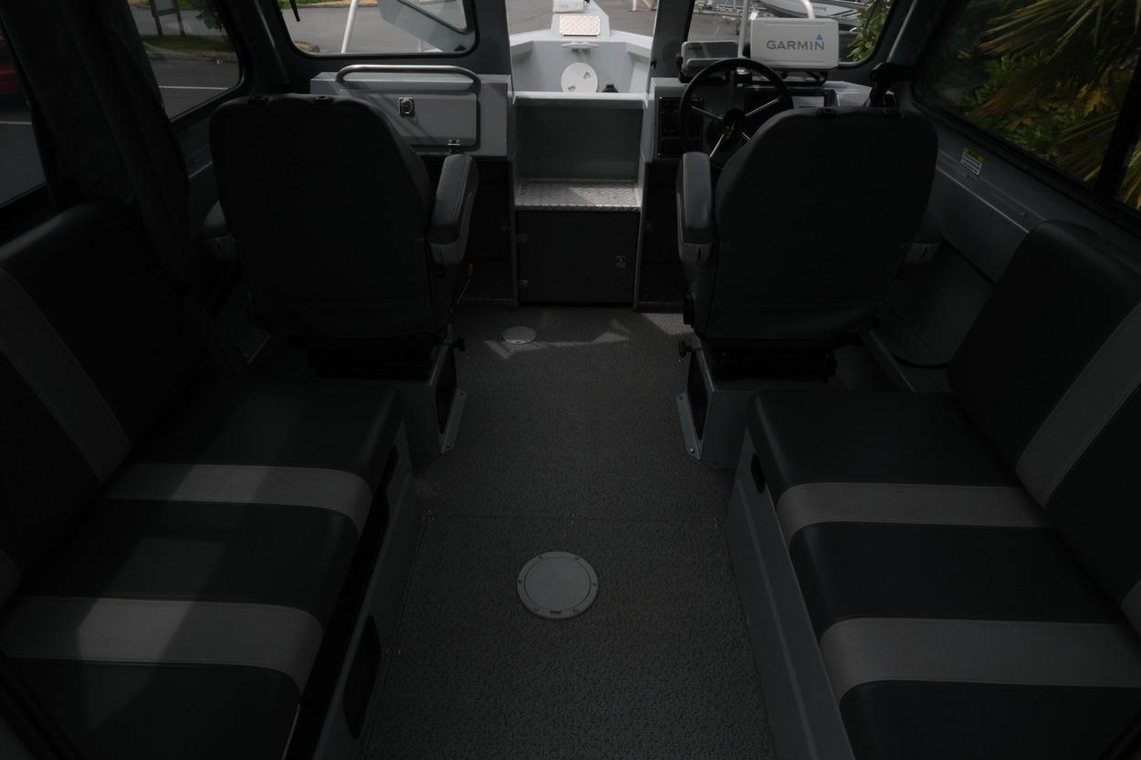 Interior of 2021 Hewescraft 240 Ocean Pro ET Hardtop with seating and steering console.