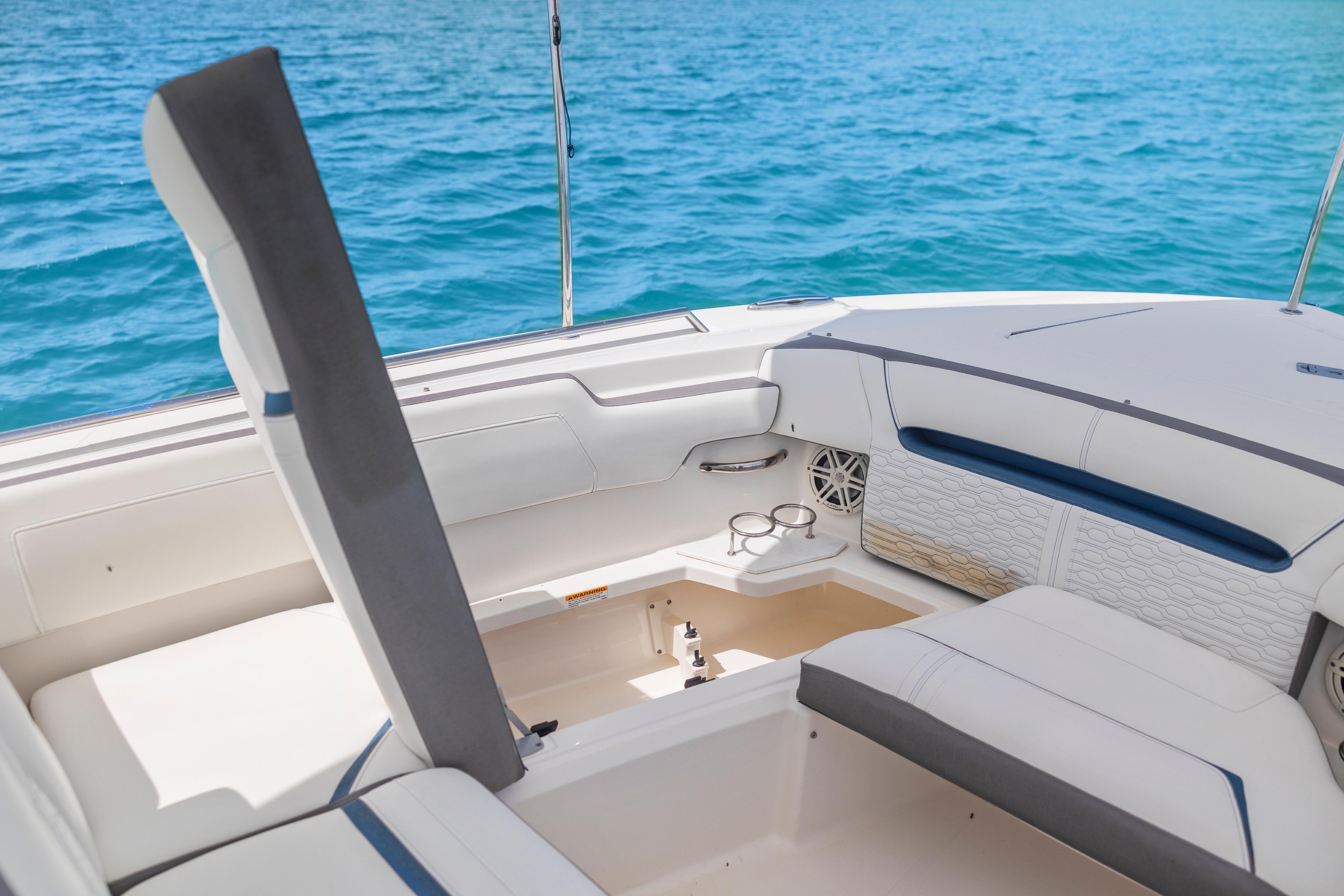 2021 Tiara Sport 34 LS boat interior with white seating and ocean backdrop.