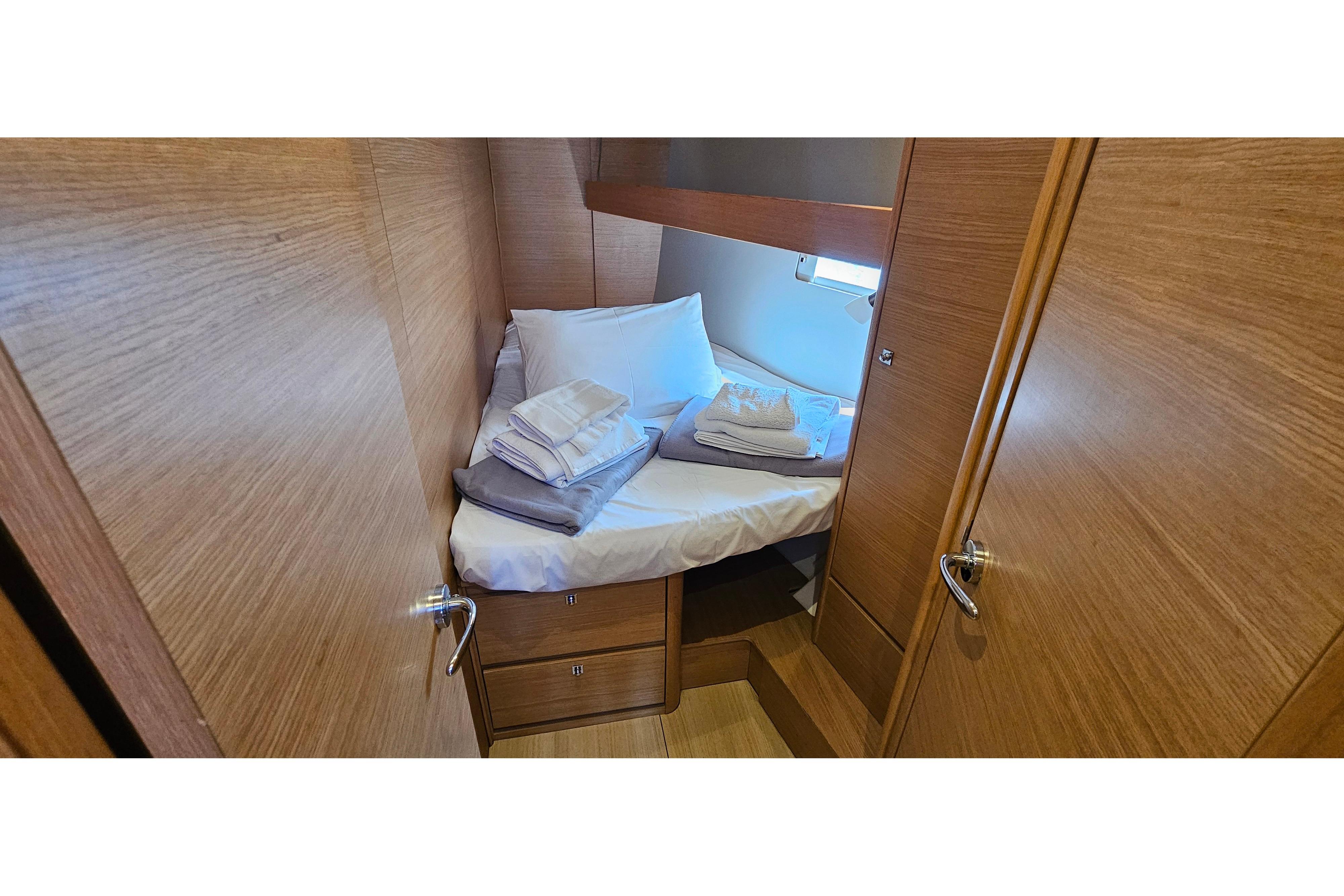 Cozy cabin interior of 2020 Dufour 460 yacht with neatly arranged bedding.