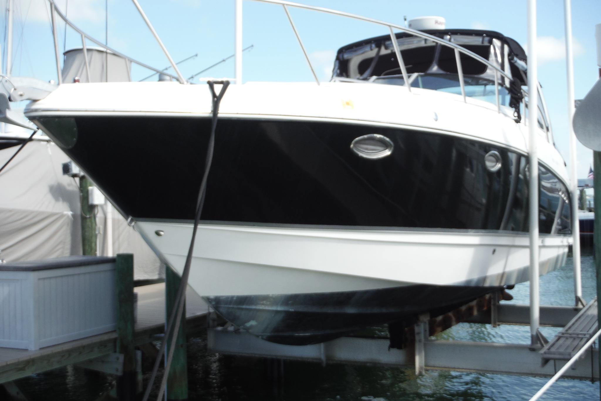 2005 Chaparral Signature 350 yacht docked at marina, black and white hull visible.