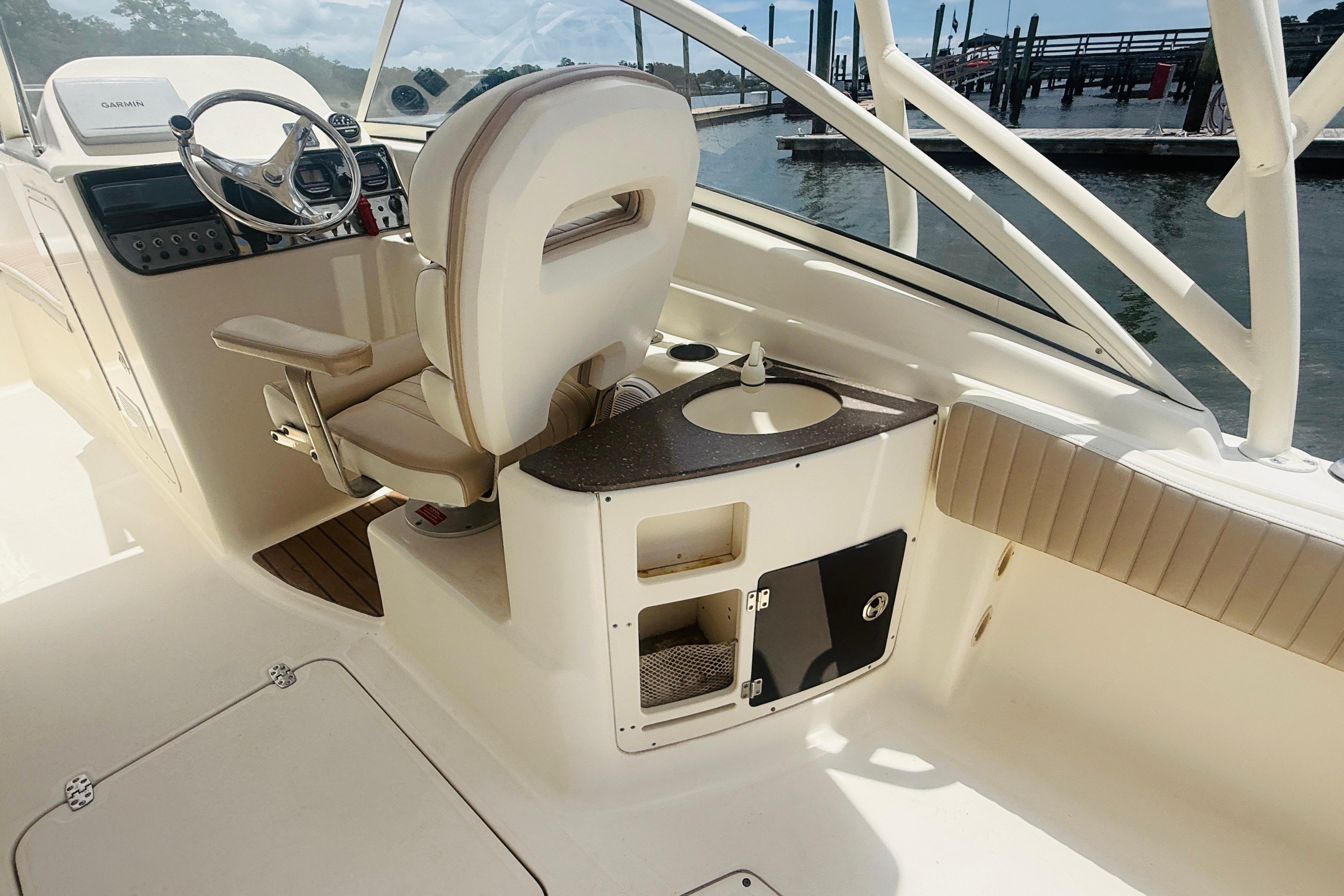Interior of 2012 Scout 245 Dorado boat with helm and seating area.