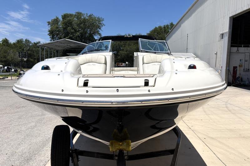 2007 Sea Ray 240 Sundeck boat on trailer, front view, outdoors.