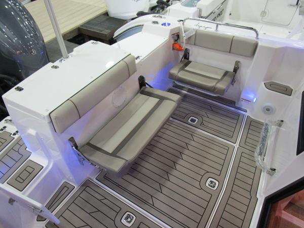 2025 Cutwater C-248 Coupe boat interior with foldable seats and teak-style flooring.