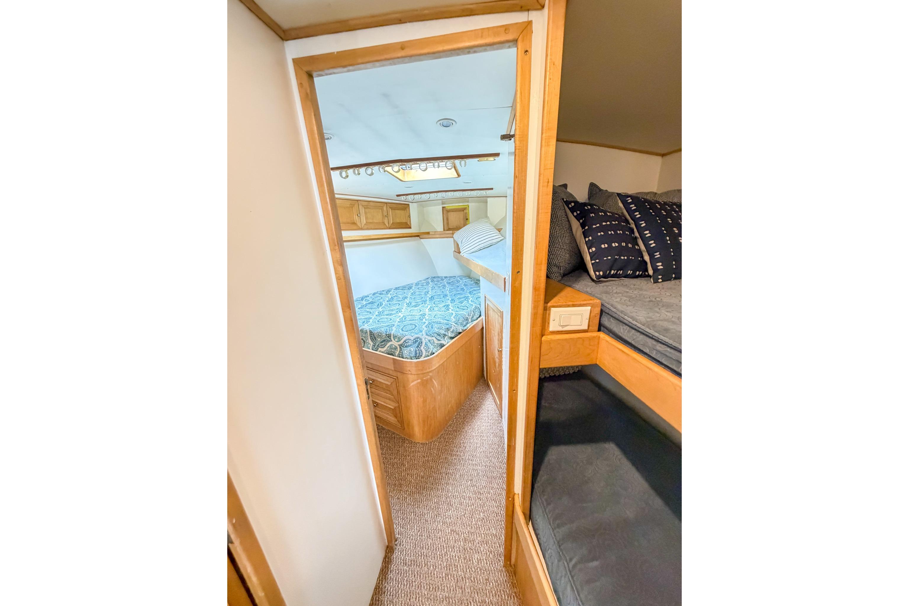 Interior of 1998 Blackwell Custom Carolina Sportfish with cozy sleeping quarters and wooden accents.