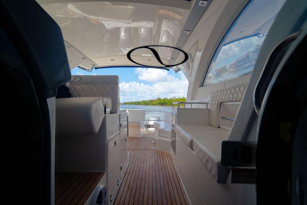 Interior view of 2022 Schaefer 400 Sport yacht with luxurious seating and wooden flooring.