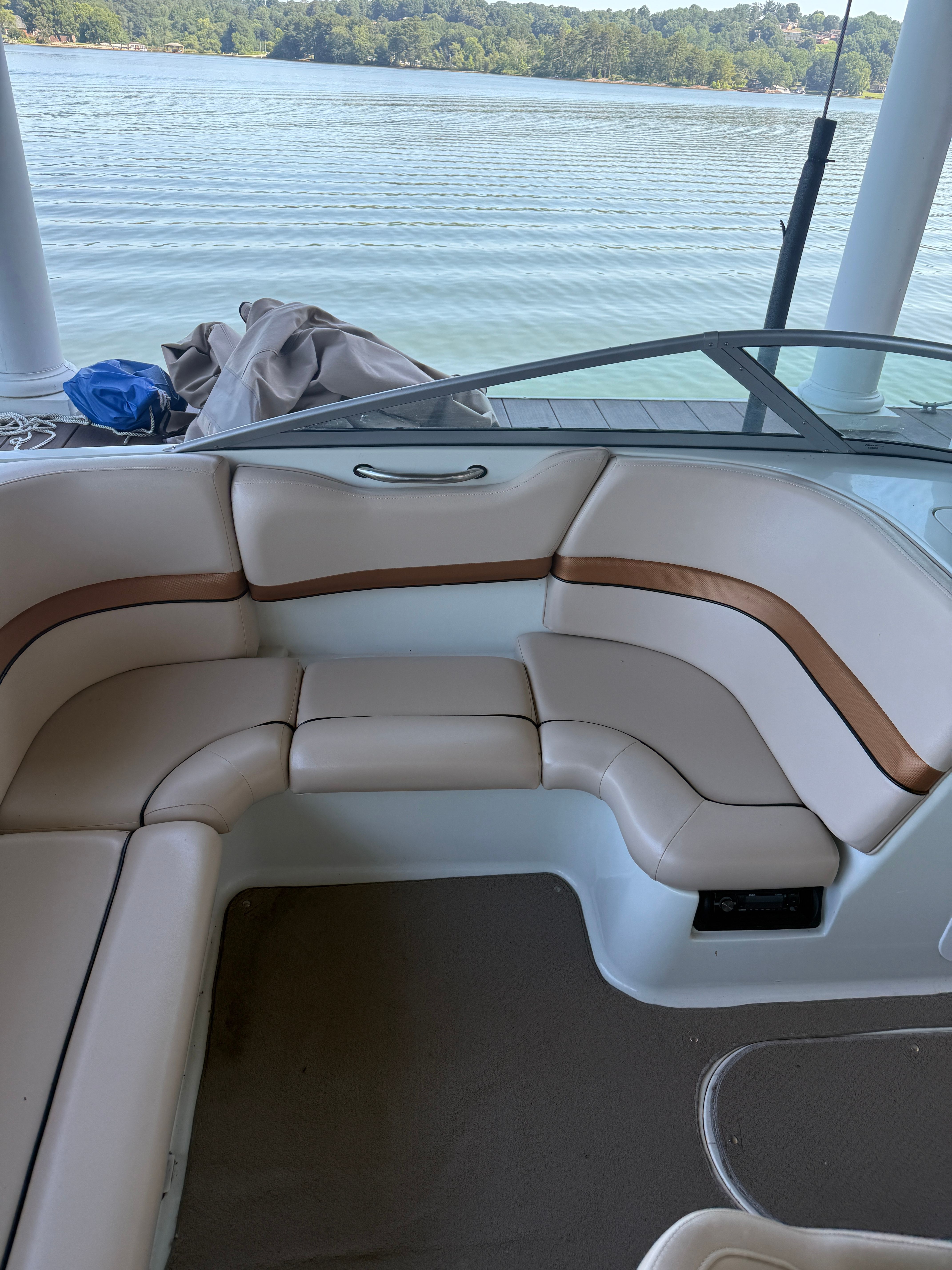 The image shows the cockpit of a Starcraft Next Star 19 boat with beige seating.