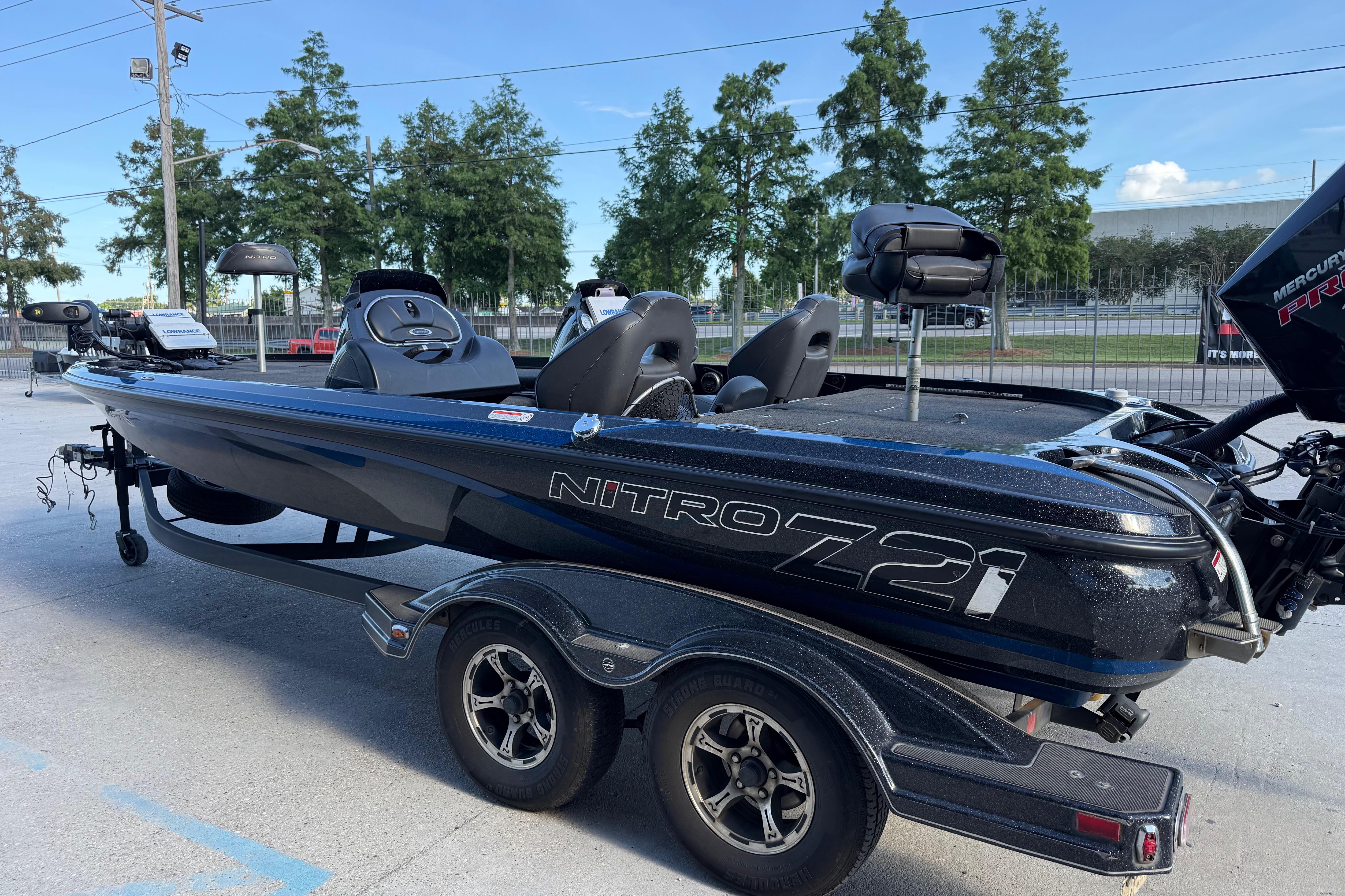 2018 Nitro Z21 boat on trailer, parked outdoors with trees in background.
