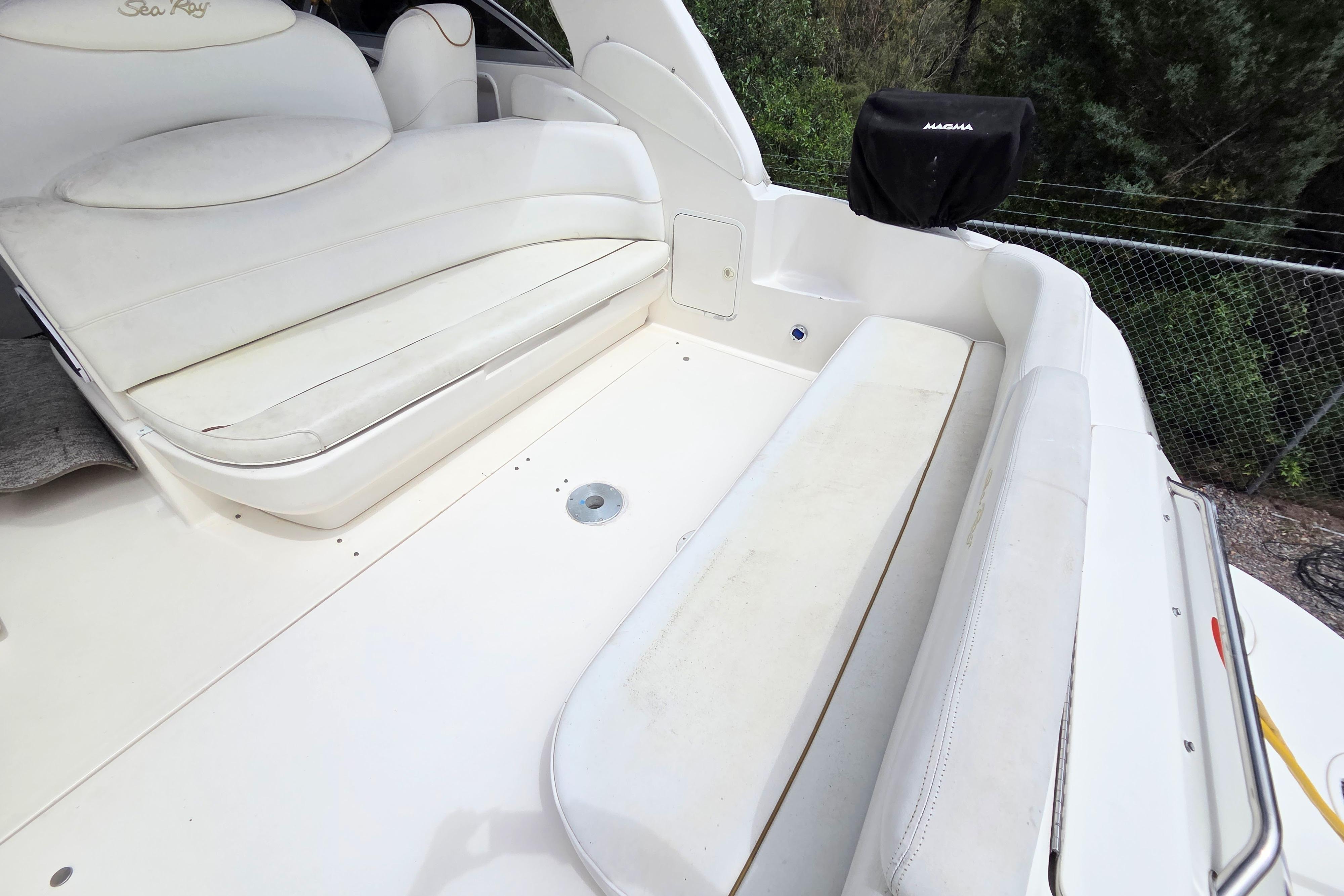 2000 Sea Ray 340 Sundancer boat interior with white seating and outdoor view.