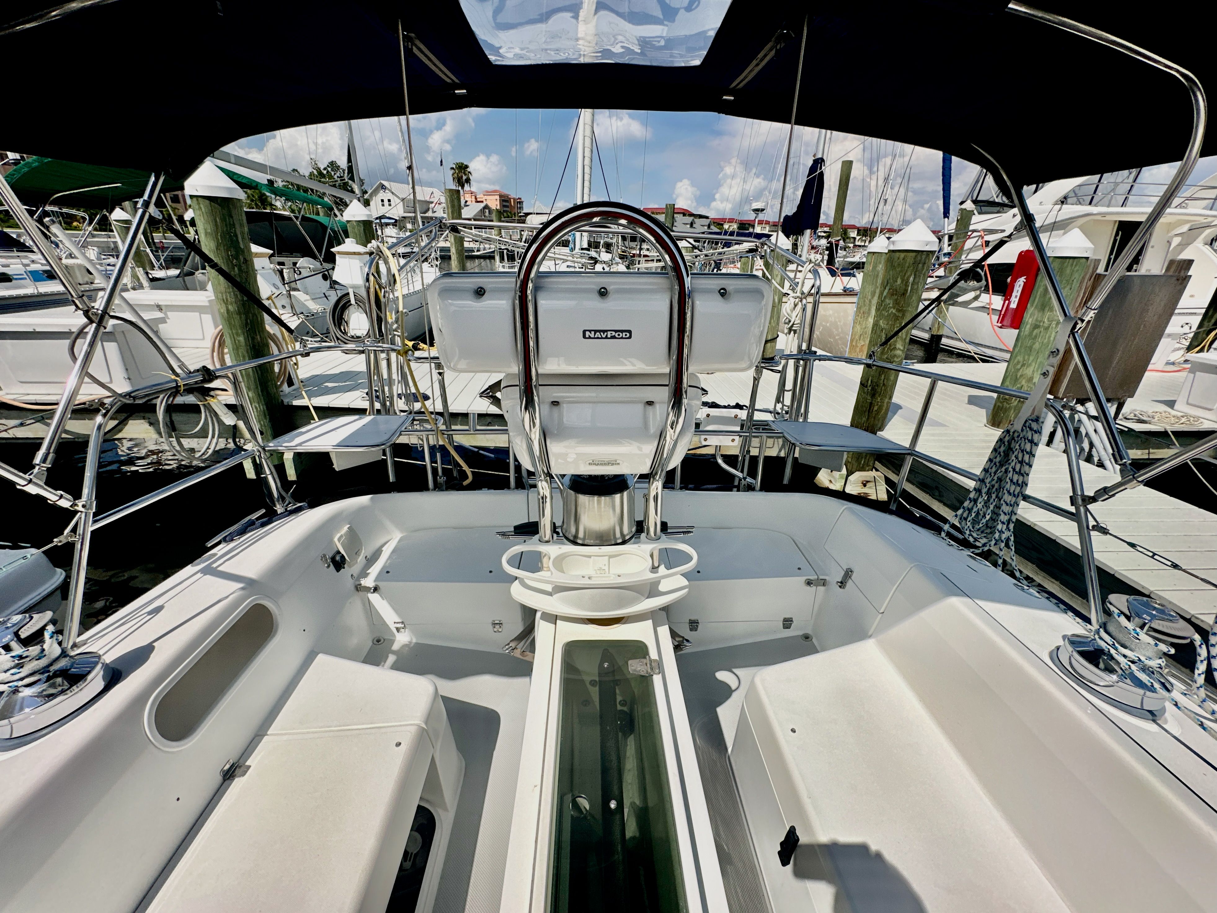 Cockpit view of a 2005 Catalina 36 sailboat docked at a marina.