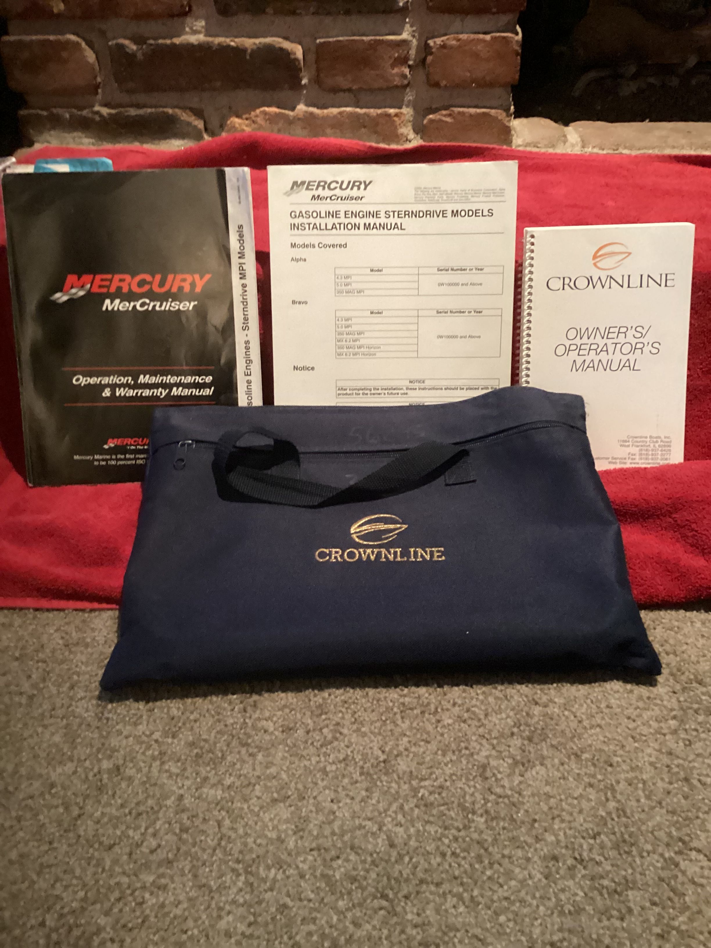 Crownline 202 BR LPX 2005 manuals and bag on carpet.