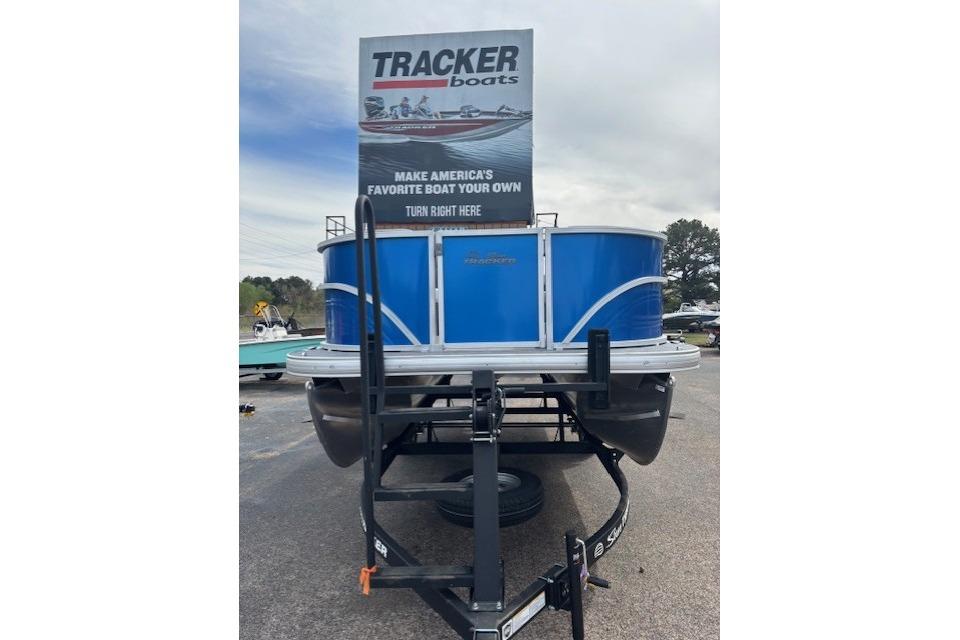 2026 Sun Tracker Party Barge 16 DLX pontoon boat on trailer, displayed outdoors.