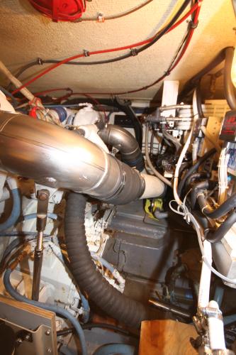 Engine room of a yacht with complex piping and wiring.