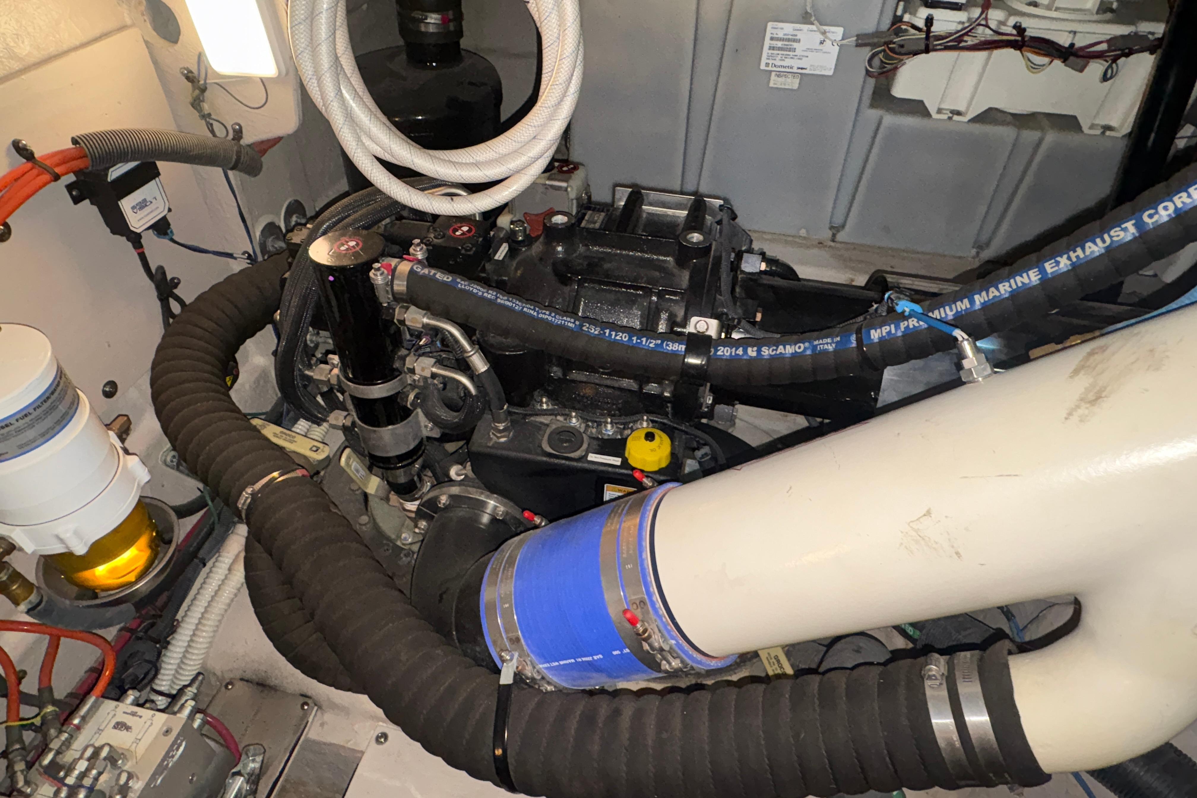 Engine room of 2015 Sea Ray 470 Sundancer with visible hoses and components.