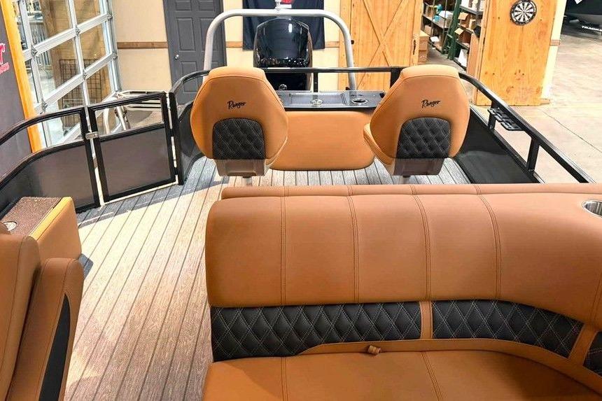 Interior of 2026 Ranger 220F boat with tan and black seating, modern design.