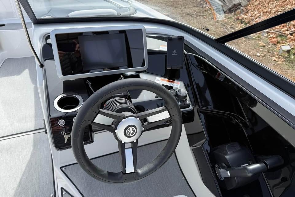 2026 Yamaha Boats AR250 dashboard with steering wheel and touchscreen display.