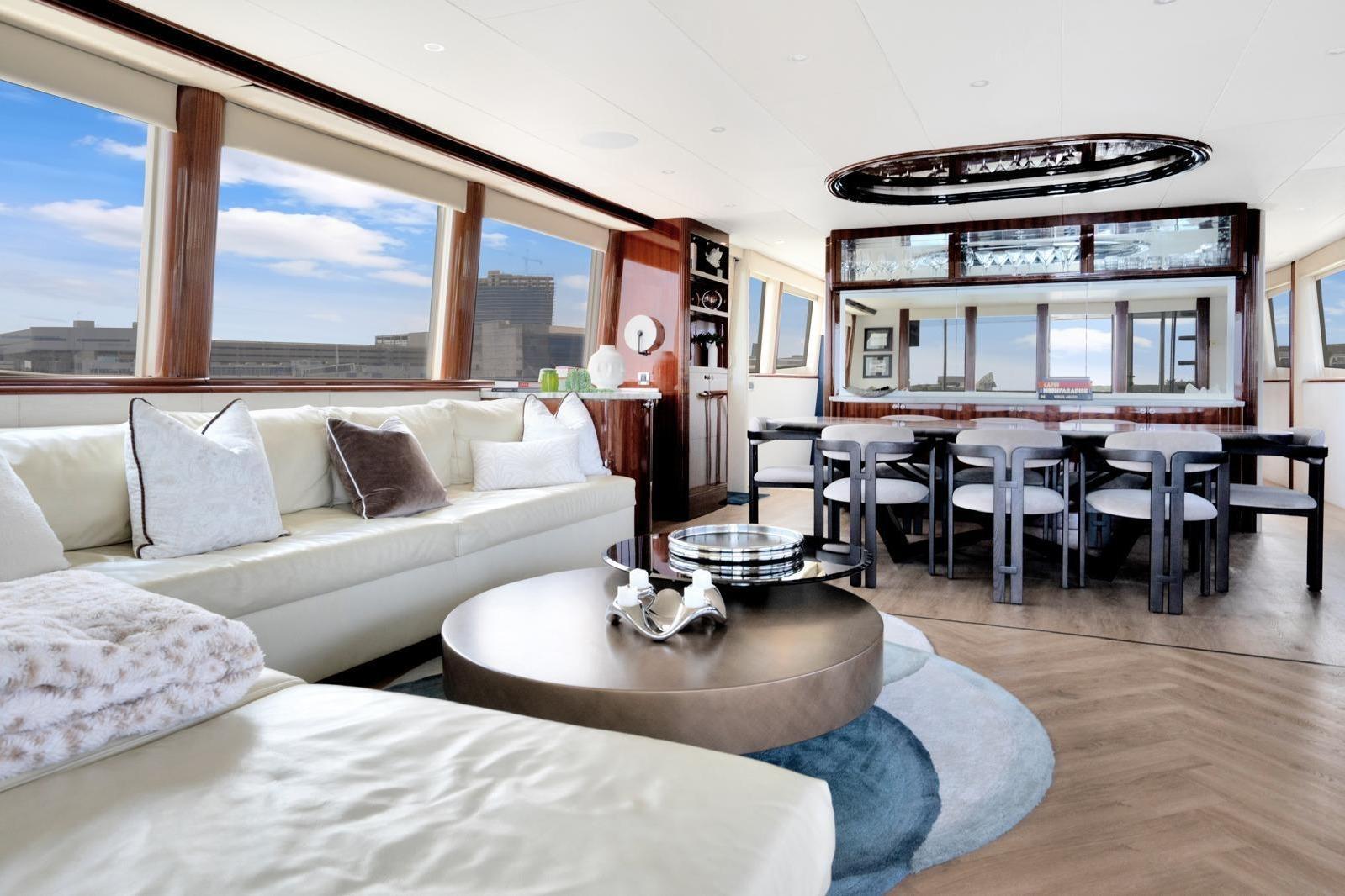 Luxurious interior of 2001 Lazzara Motoryacht with elegant seating and dining area.