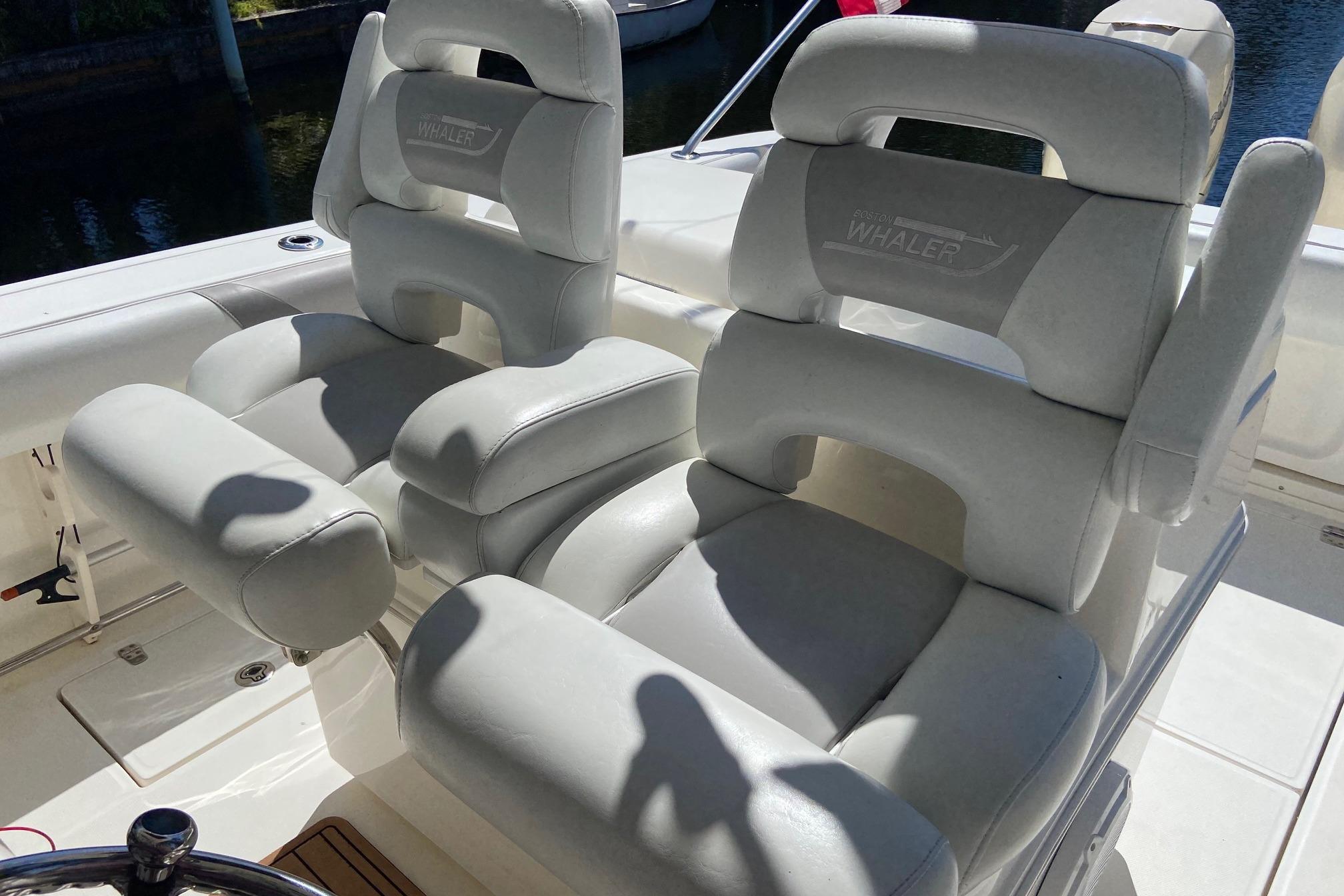 Luxury seating on a 2011 Boston Whaler 320 Outrage boat, featuring plush white upholstery.