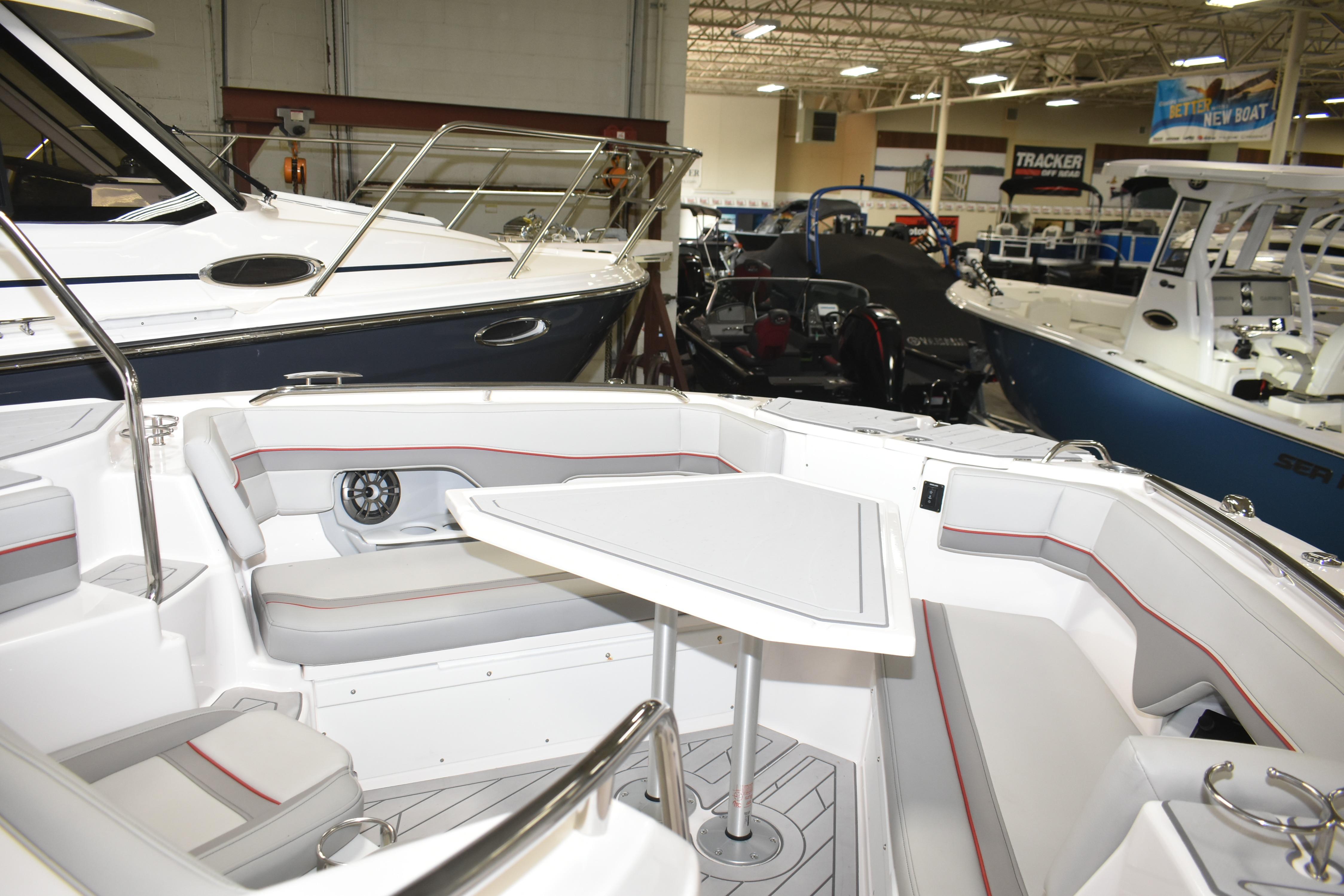 2025 Solara S-310 CW boat interior with seating and table in showroom.