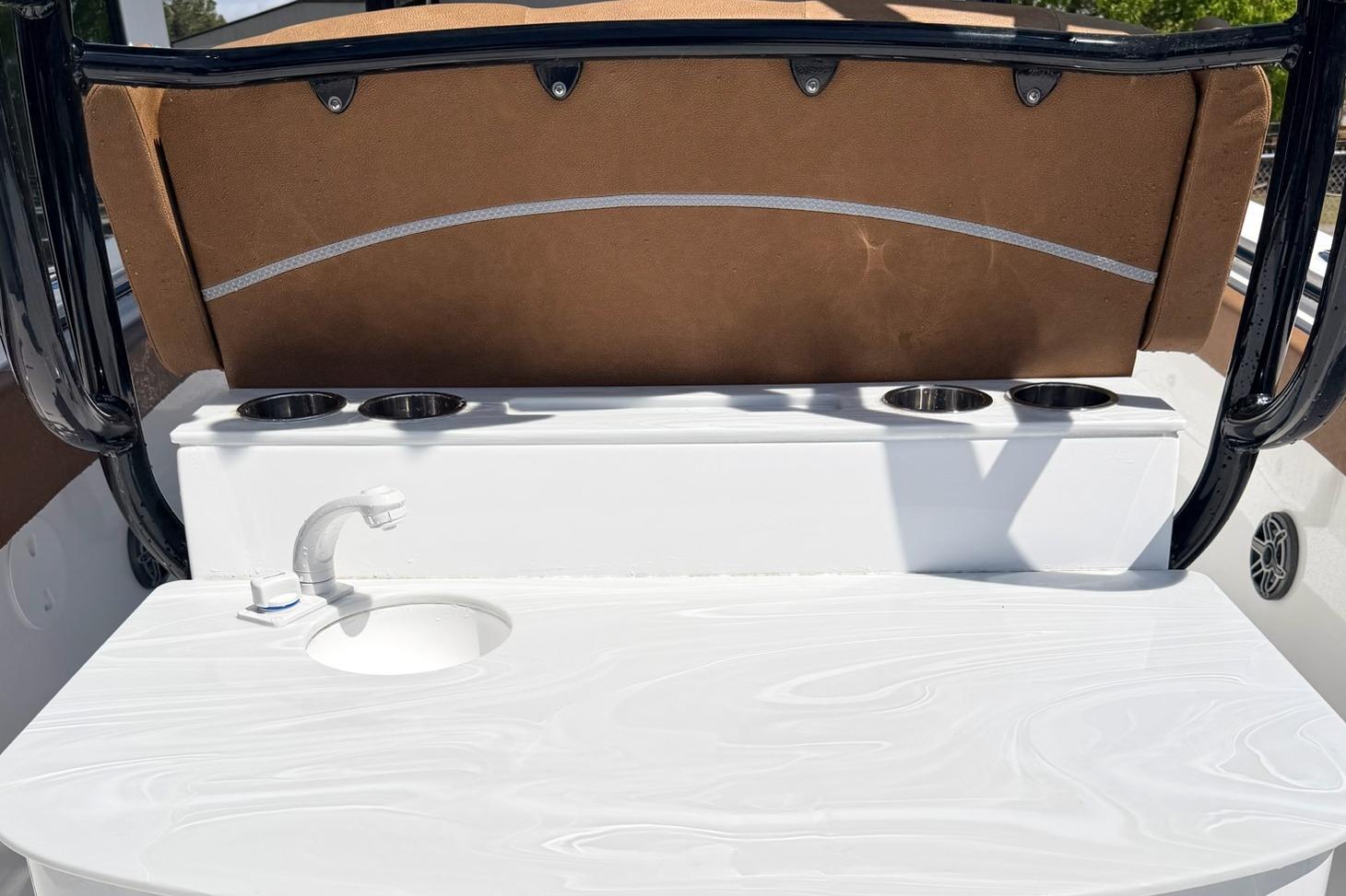 2026 Seahunt Ultra 305 CB boat interior with sink and cup holders.