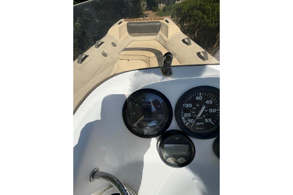 2016 Walker Bay Generation 450 DLX boat dashboard with gauges and steering wheel.