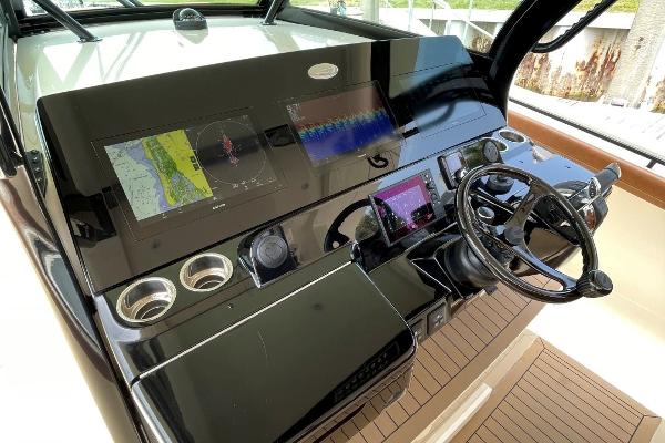 2020 Scout 420 LXF boat dashboard with navigation screens and steering wheel.