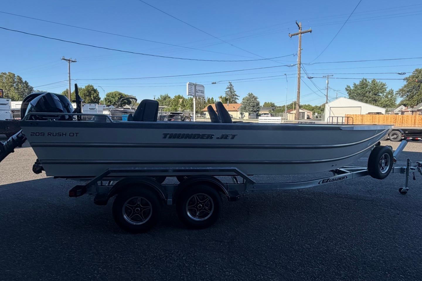 2026 Thunder Jet 209 Rush OT boat on trailer, parked outdoors.