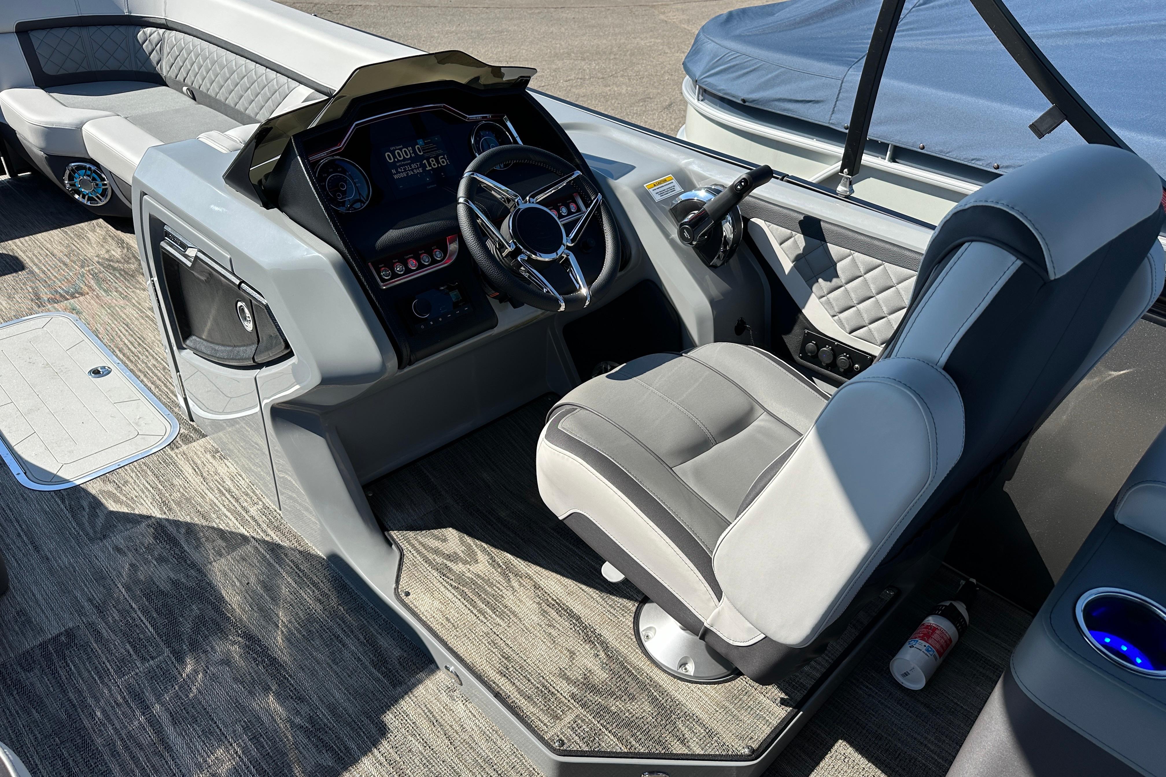 2025 Godfrey AquaPatio 255 SB boat interior with modern helm and seating.