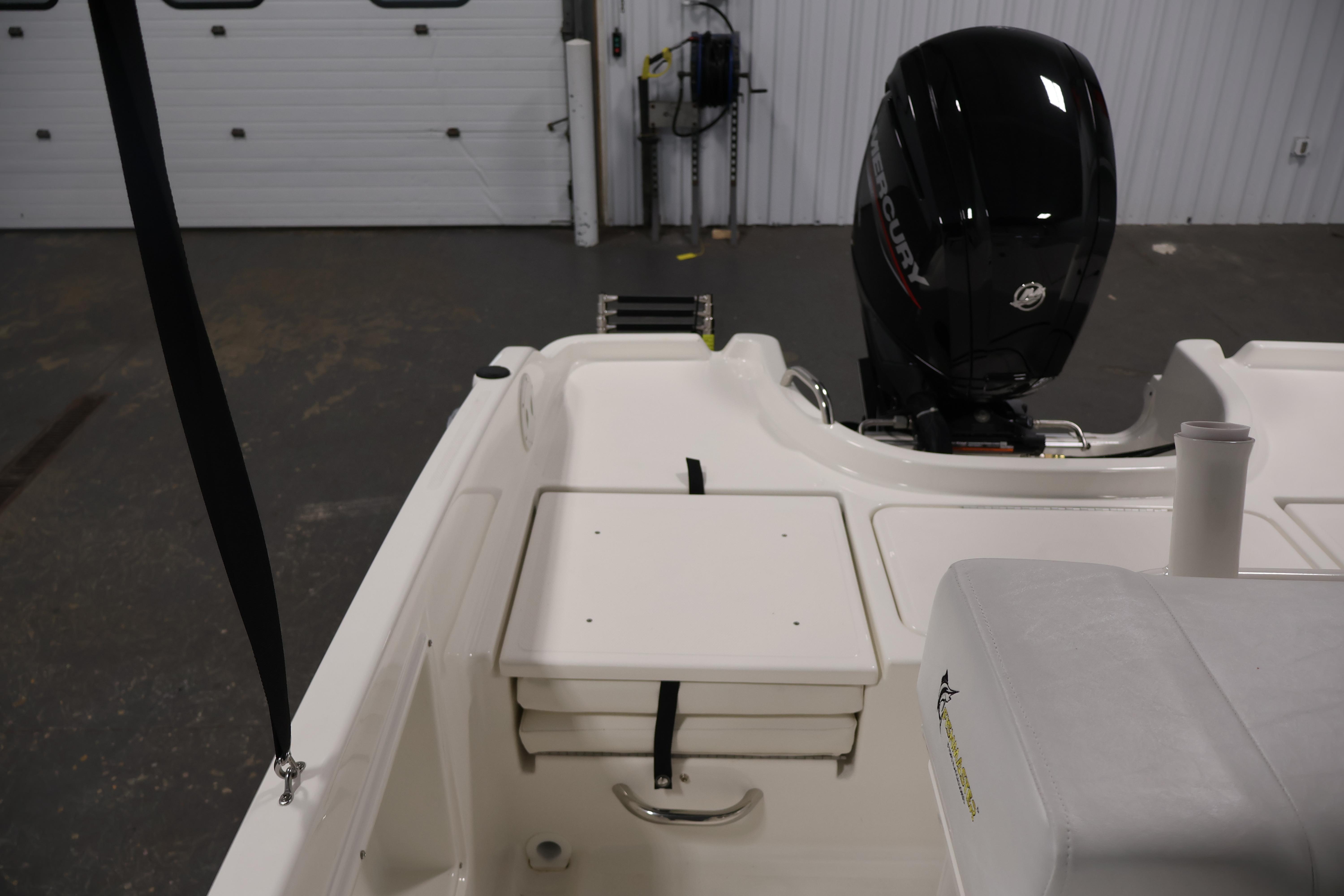2026 Bayliner Trophy T18 boat interior with Mercury engine in a garage setting.