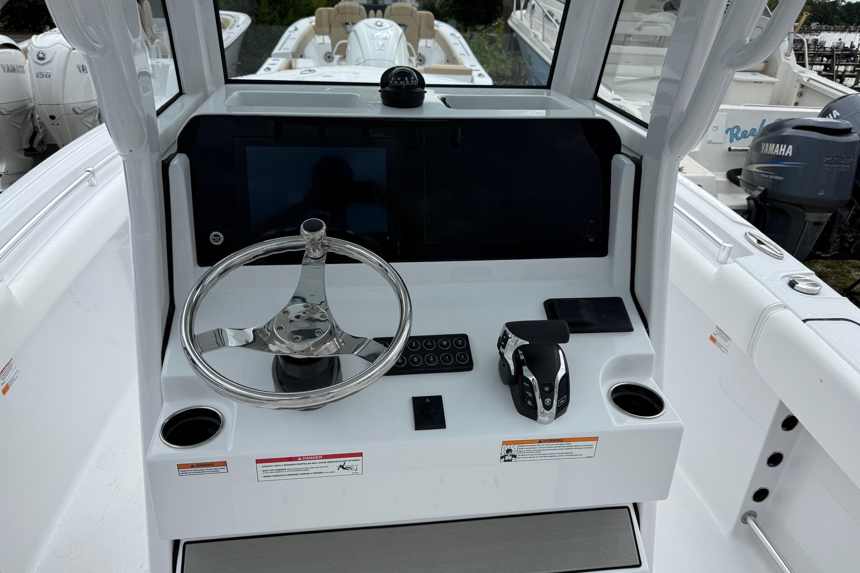 2026 Sportsman Heritage 231 Center Console helm with steering wheel and controls.
