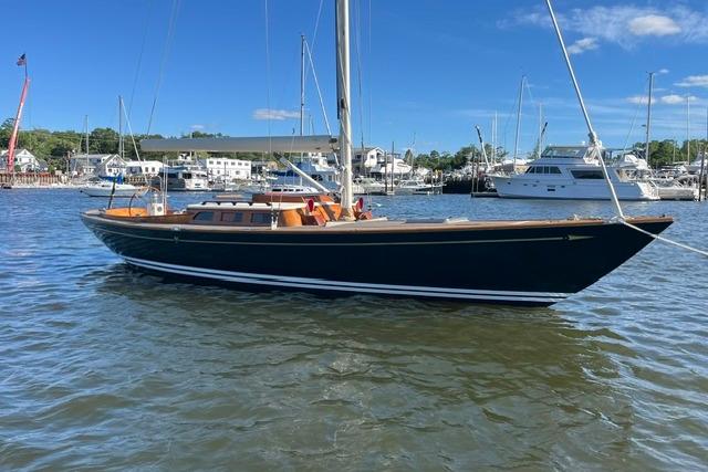 Sailboat Morris 36, 2006 model, docked in a marina with clear skies.