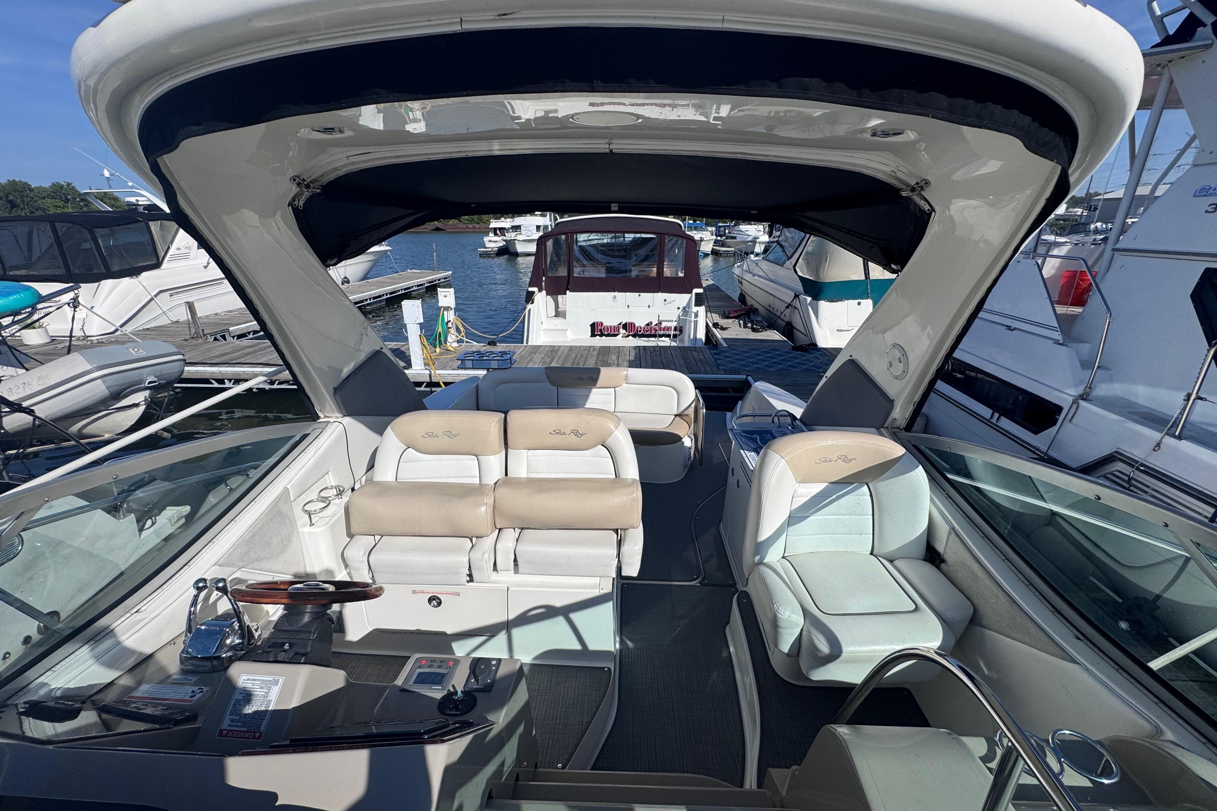 2008 Sea Ray 350 Sundancer interior with seating, docked among other boats.