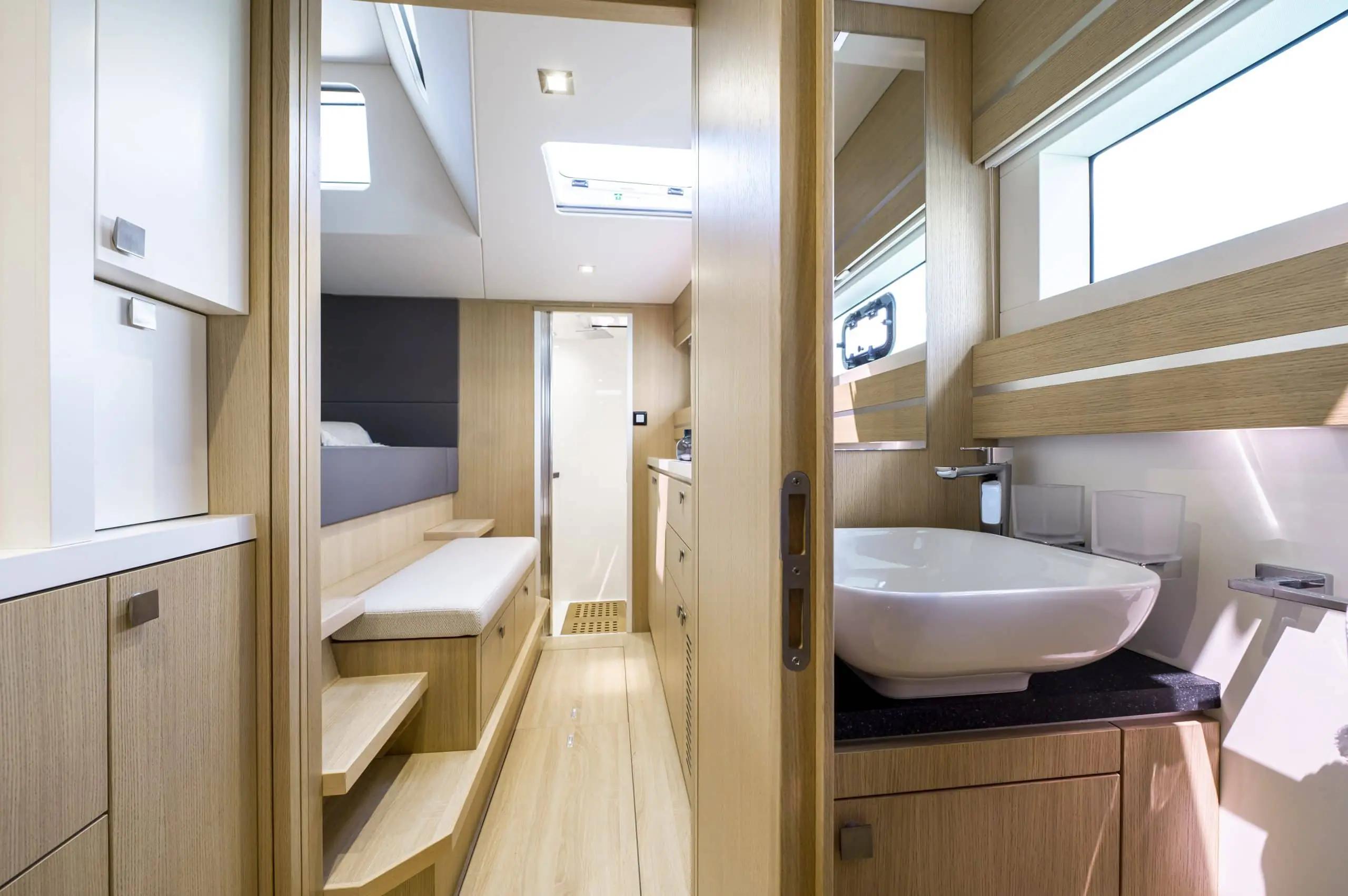 Luxurious interior of 2026 Privilege Signature 510 yacht with modern bathroom and seating area.
