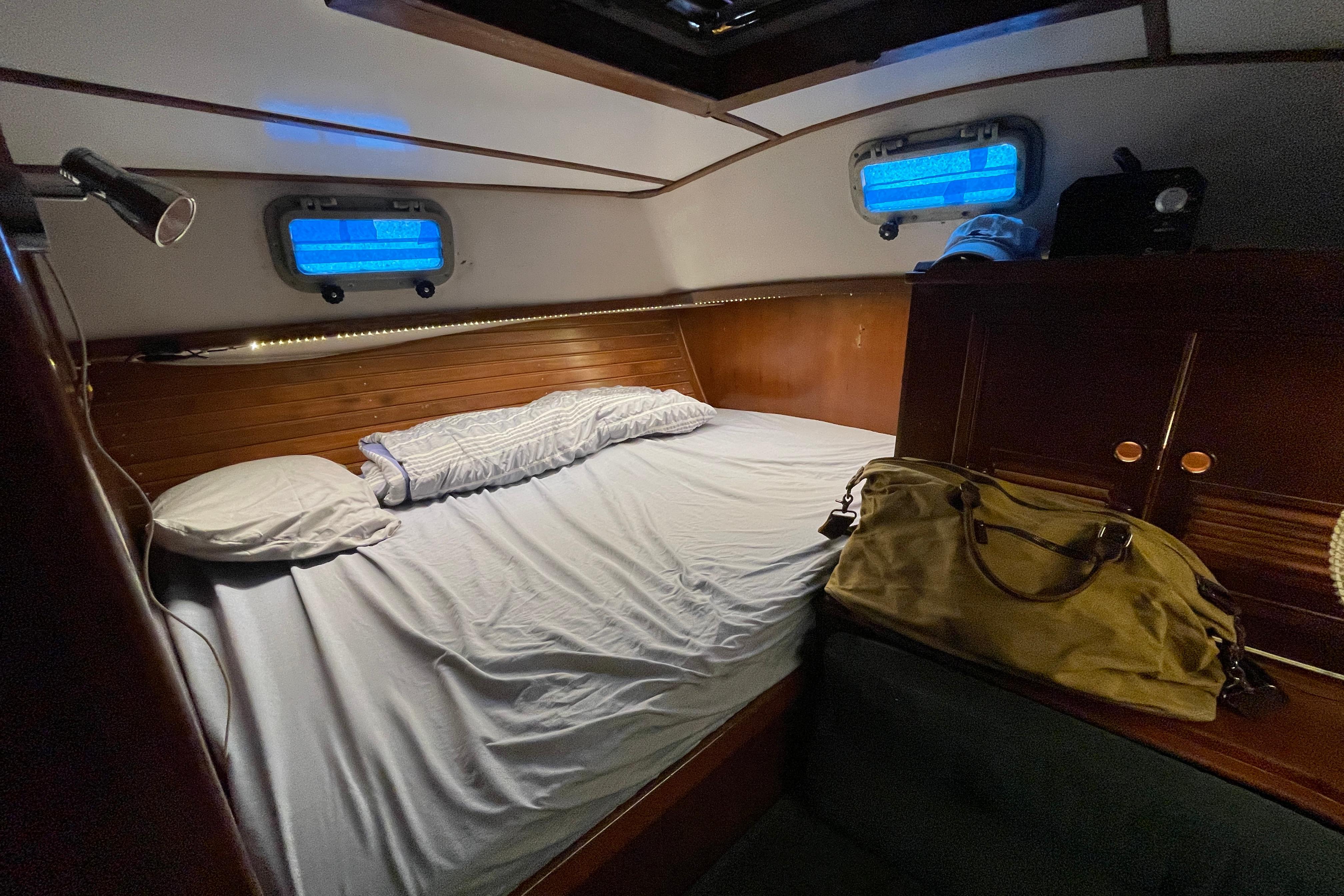 Cozy cabin interior of 1984 TA Chaio CT47 yacht with bed and portholes.
