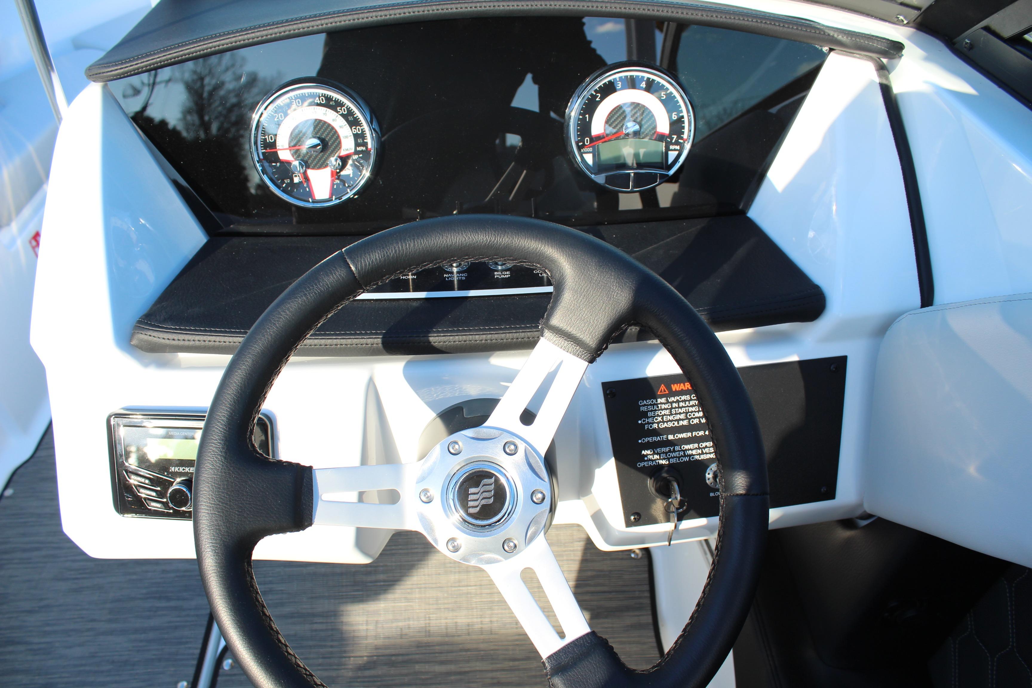 Steering wheel and dashboard of 2026 Four Winns H2 Freedom boat.
