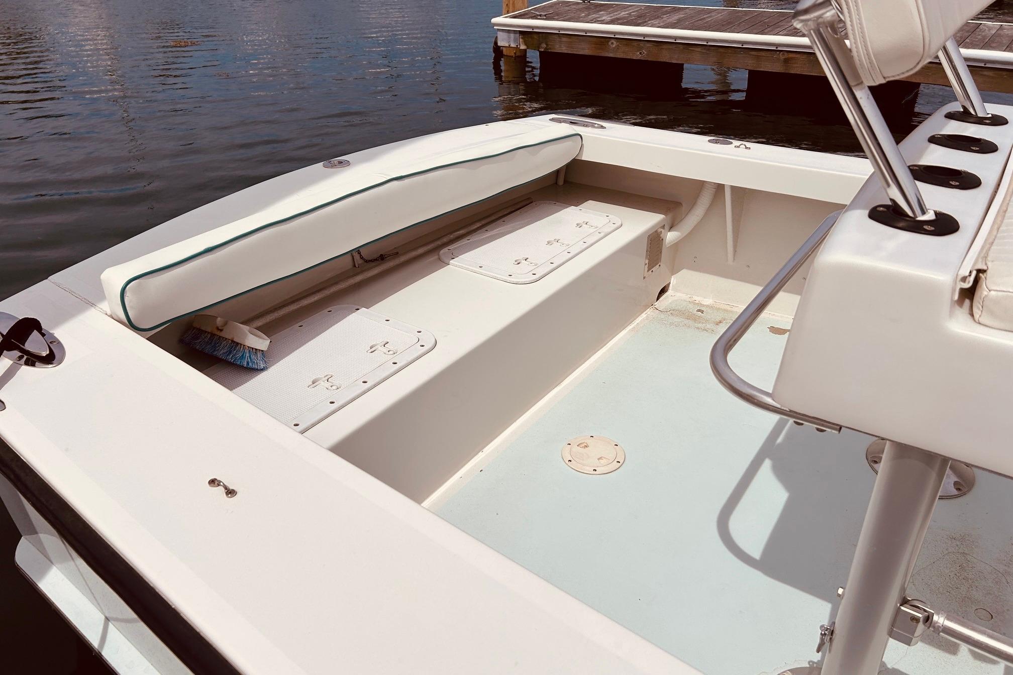 Interior of a 1999 Northshore 22 boat, featuring seating and storage compartments.