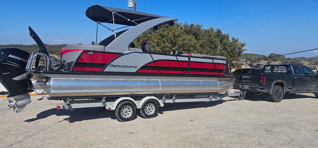 2023 Berkshire 25RFX STS 3.0 pontoon boat on trailer, towed by a truck.