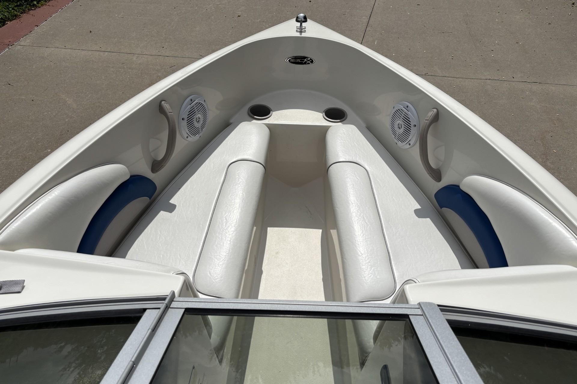 2007 Stingray 180 RX boat interior with white seating and blue accents.