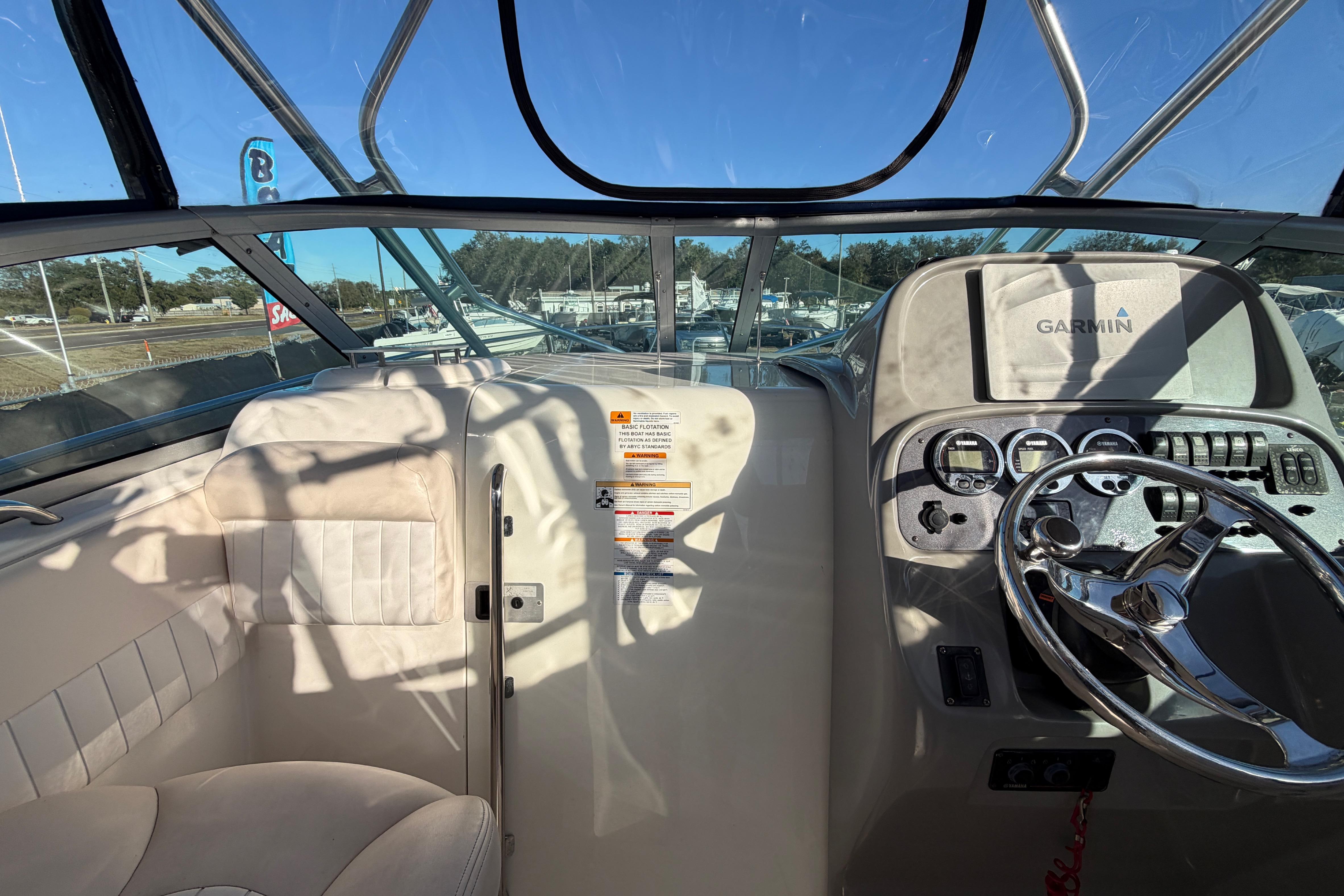 2017 Robalo R265 Walkaround boat interior with steering wheel and Garmin navigation system.