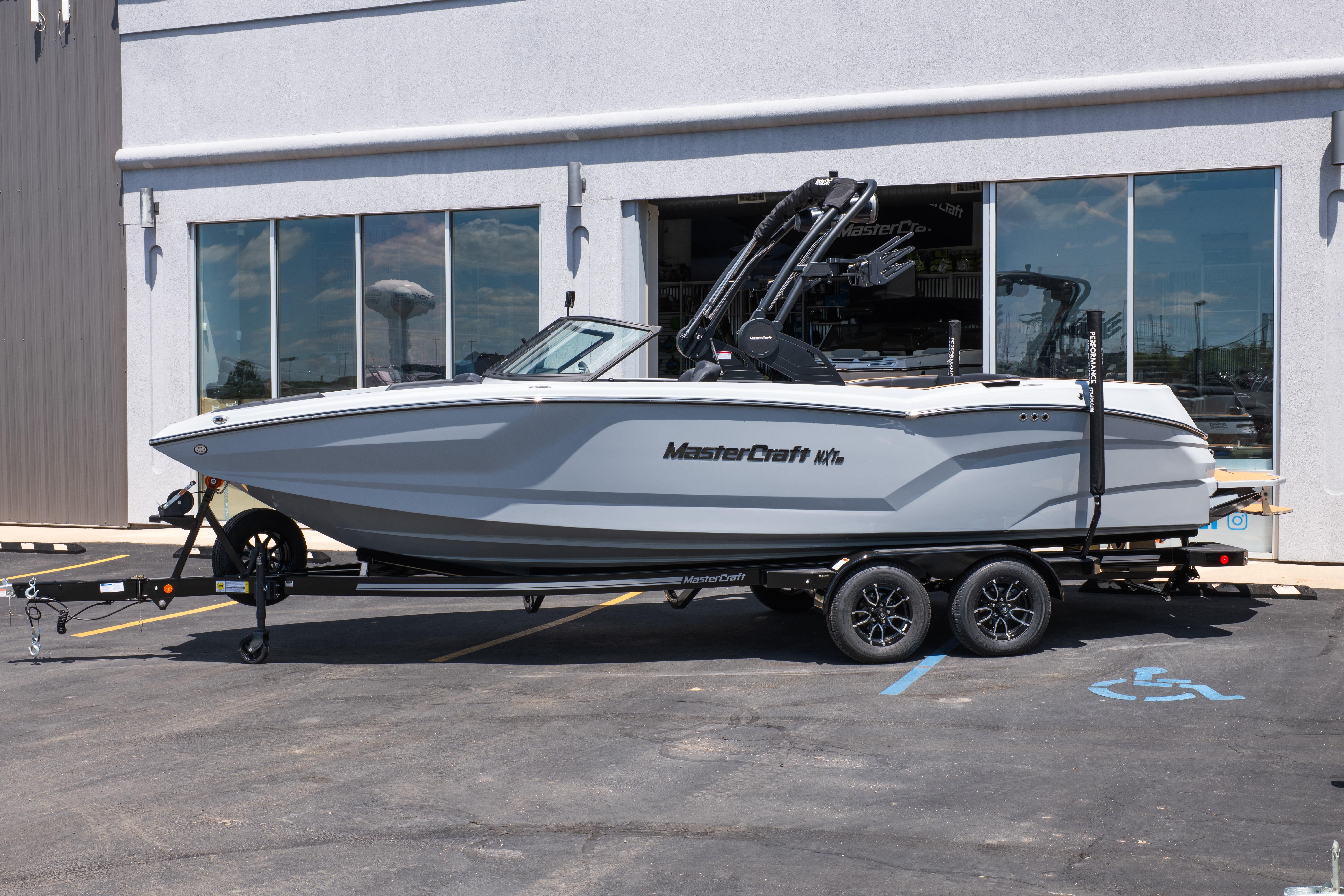 2026 MasterCraft NXT24 boat on trailer outside dealership.