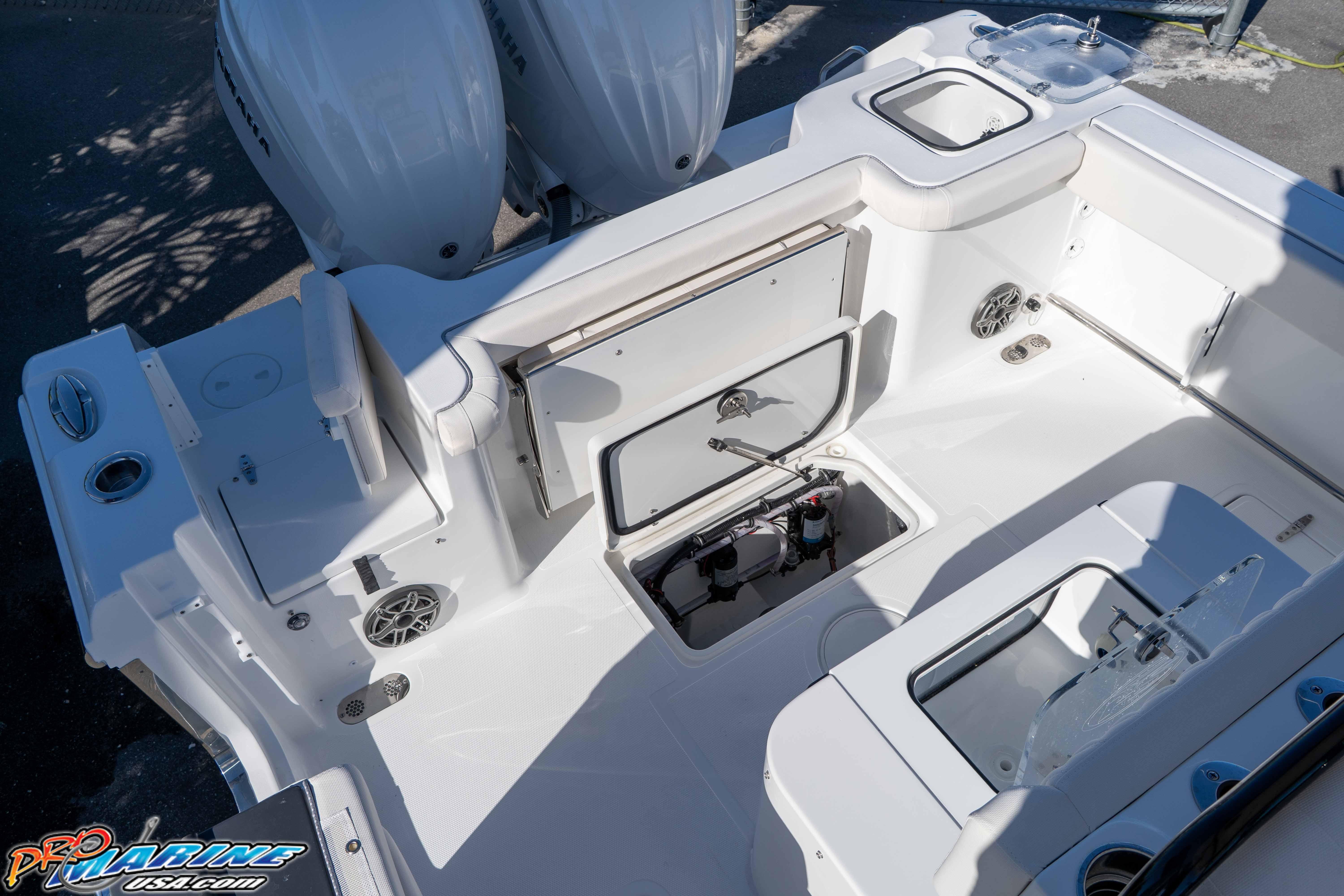 2026 Sea Hunt Gamefish 27 Coffin Box boat interior with storage compartments and dual engines.