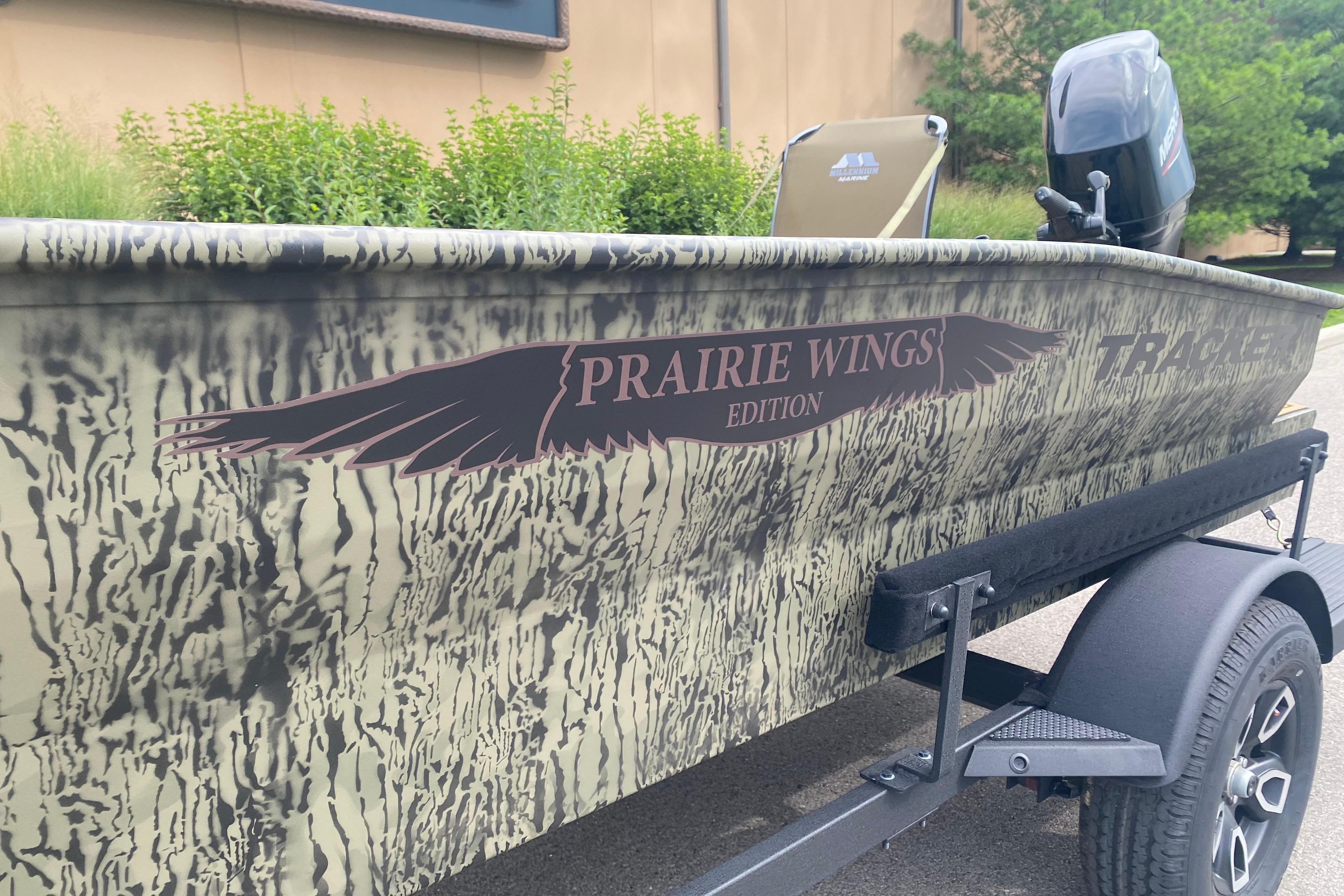 2026 Tracker Grizzly 1650 T Prairie Wings Edition boat with camouflage design on trailer.